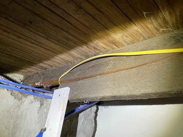 Cracked wood floor joist found above a finished basement during a home inspection