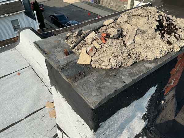 Crumbling chimney crown on an abandoned rowhouse chimney