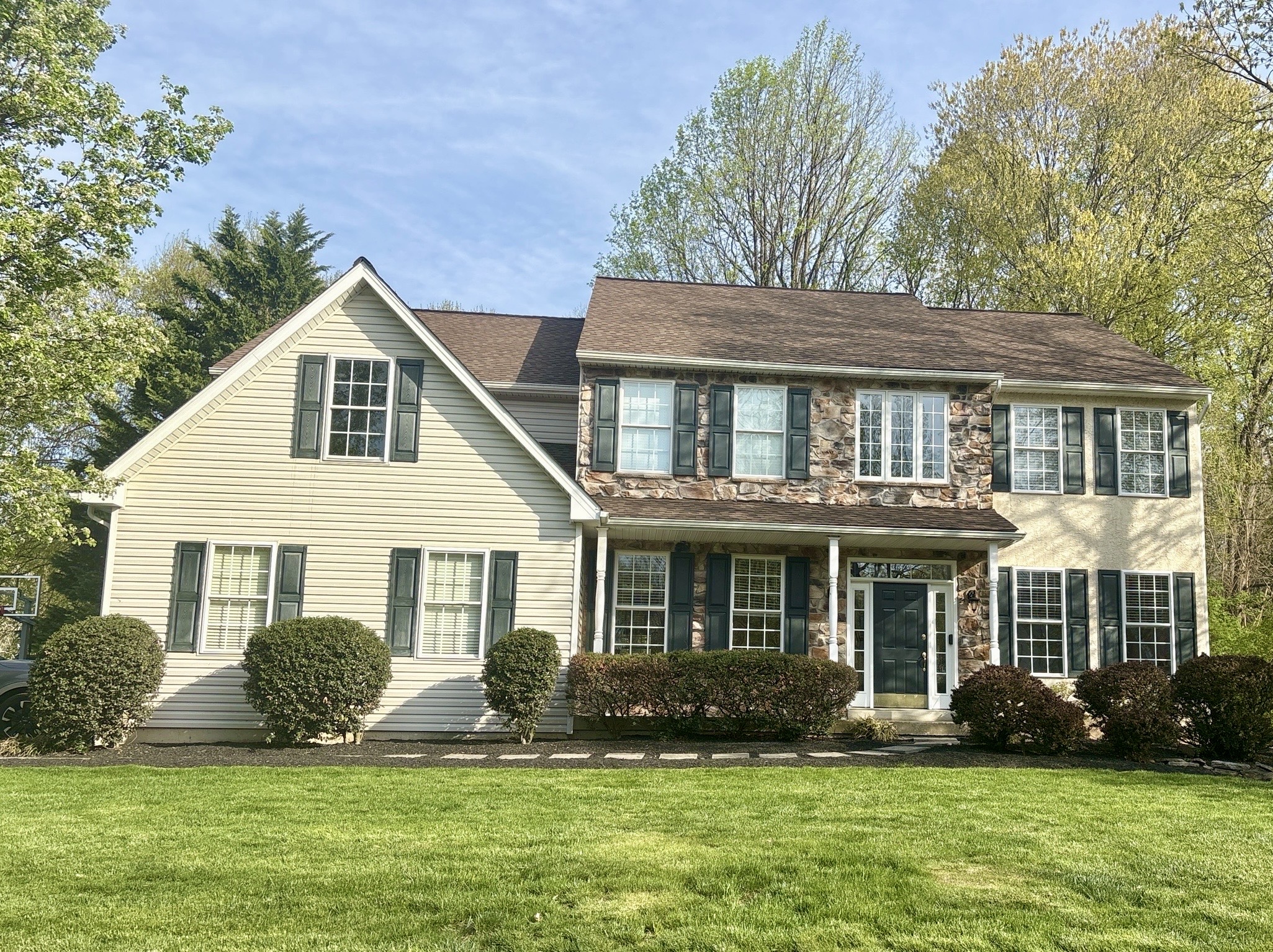 Home inspection by Nick Ostrowski — two-story colonial with stone-front accents and covered porch in Exton, Pennsylvania