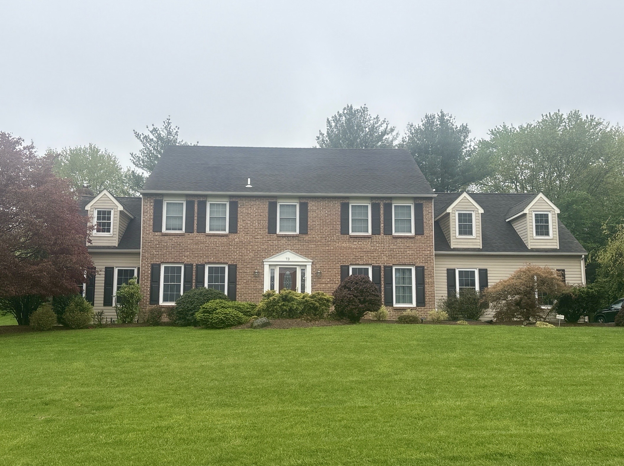 Home inspection by Nick Ostrowski — brick center-hall colonial with dormered wings on a manicured lot in Southampton, Pennsylvania