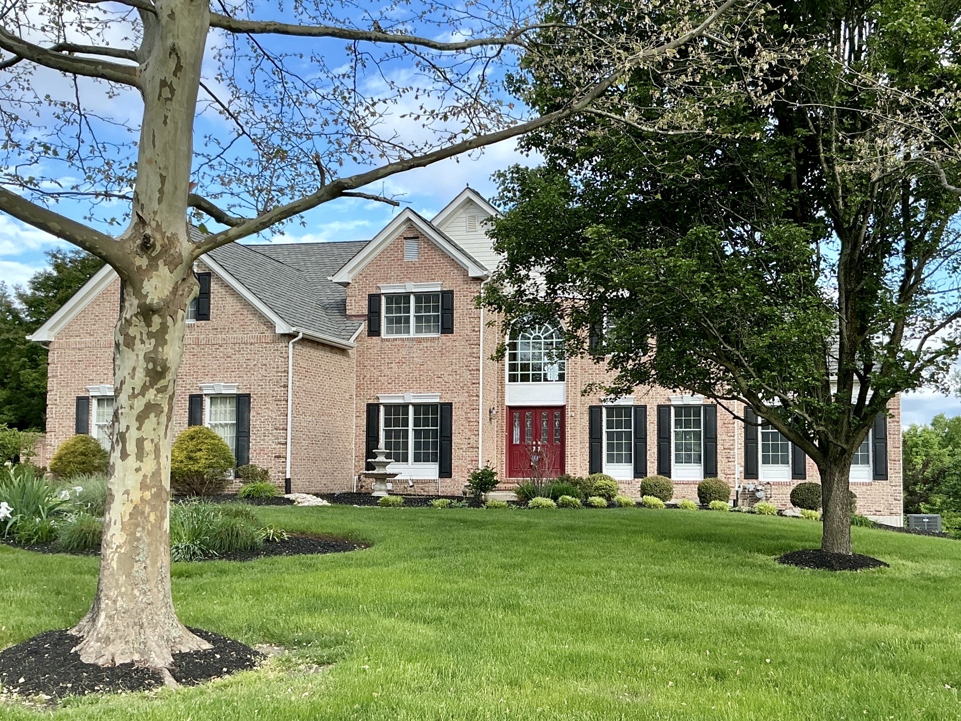 Home inspection by David Bollinger — large brick colonial estate with red door and black shutters in Doylestown, Pennsylvania