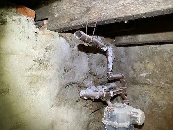 Uncapped gas pipe in a basement, flagged as a safety concern during inspection