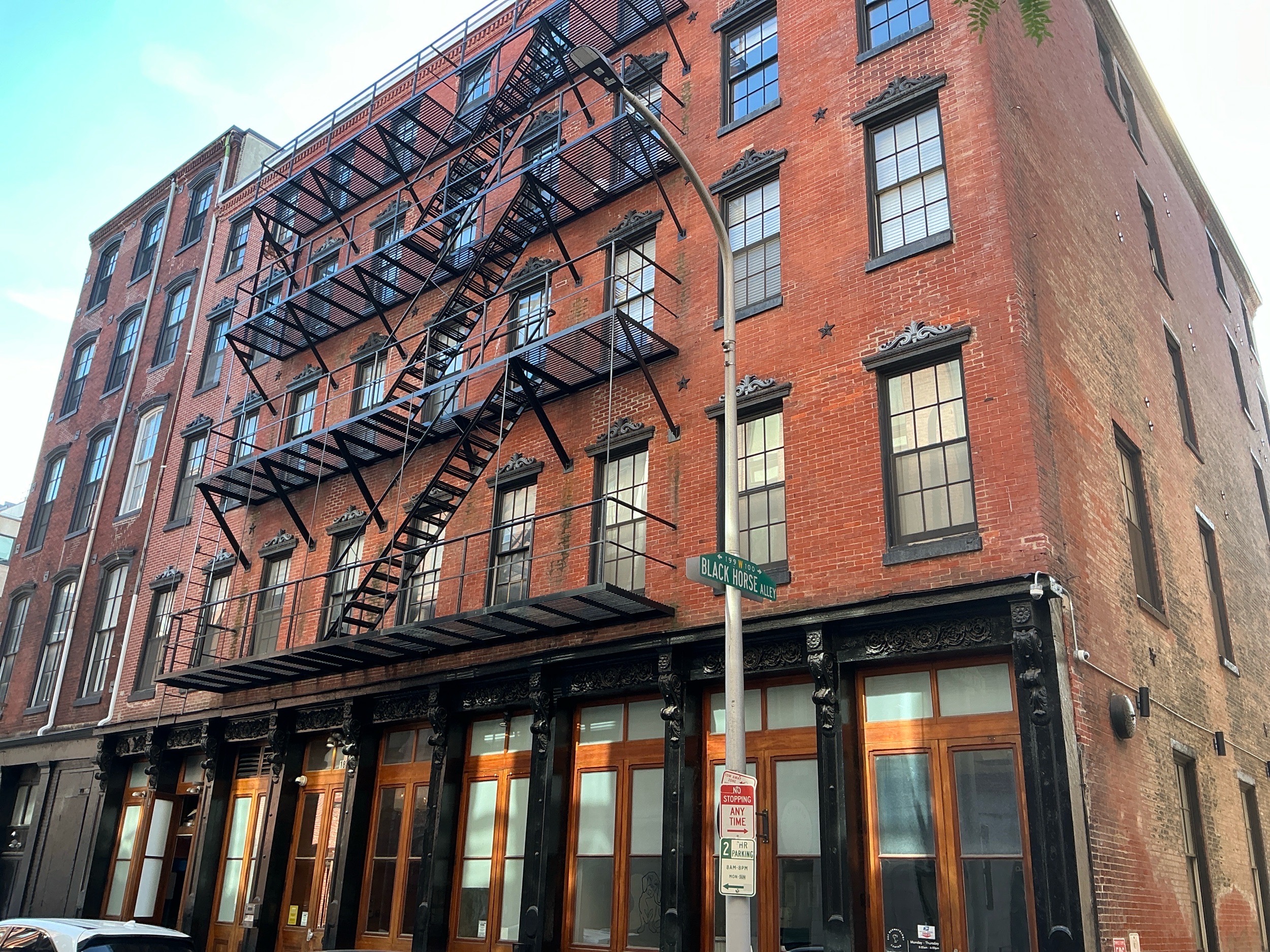 Home inspection by Steven Haslam — historic cast-iron-front brick loft building with iron fire escapes on Black Horse Alley in Old City, Philadelphia