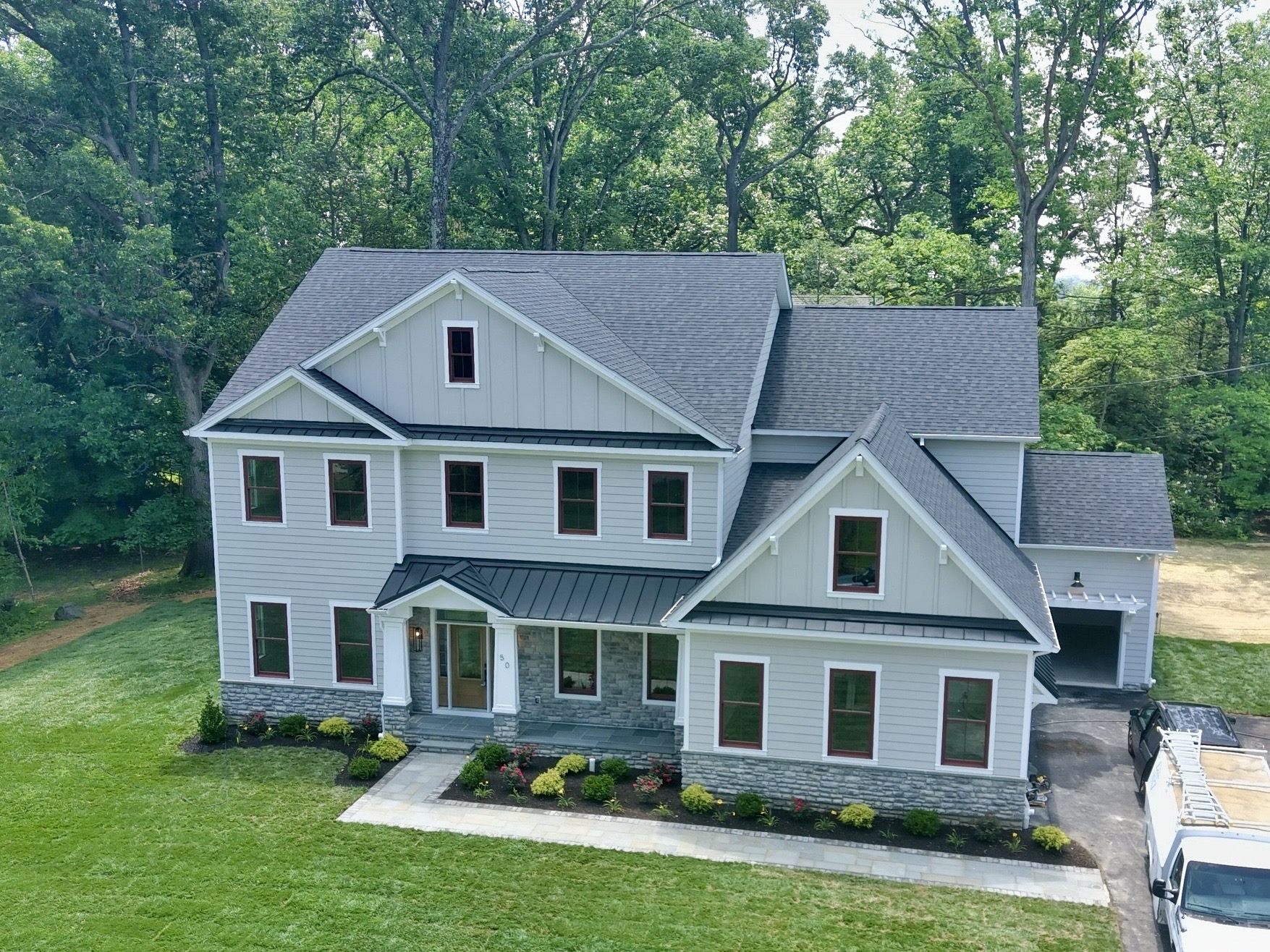 Aerial home inspection by Cory Shalaway — brand-new construction gray farmhouse with board-and-batten and stone in Wayne, Pennsylvania