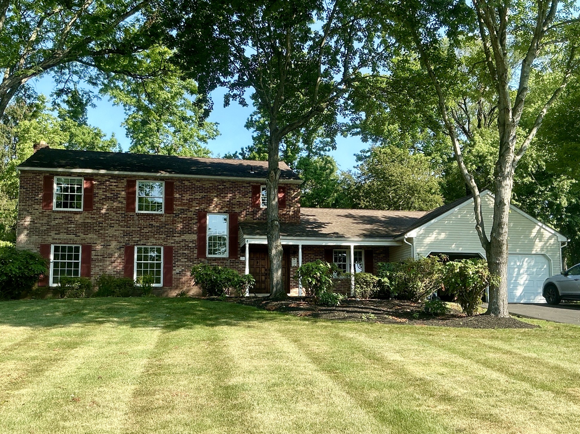 Home inspection by Joe Topper — brick colonial with red shutters on a wooded lot in Doylestown, Pennsylvania
