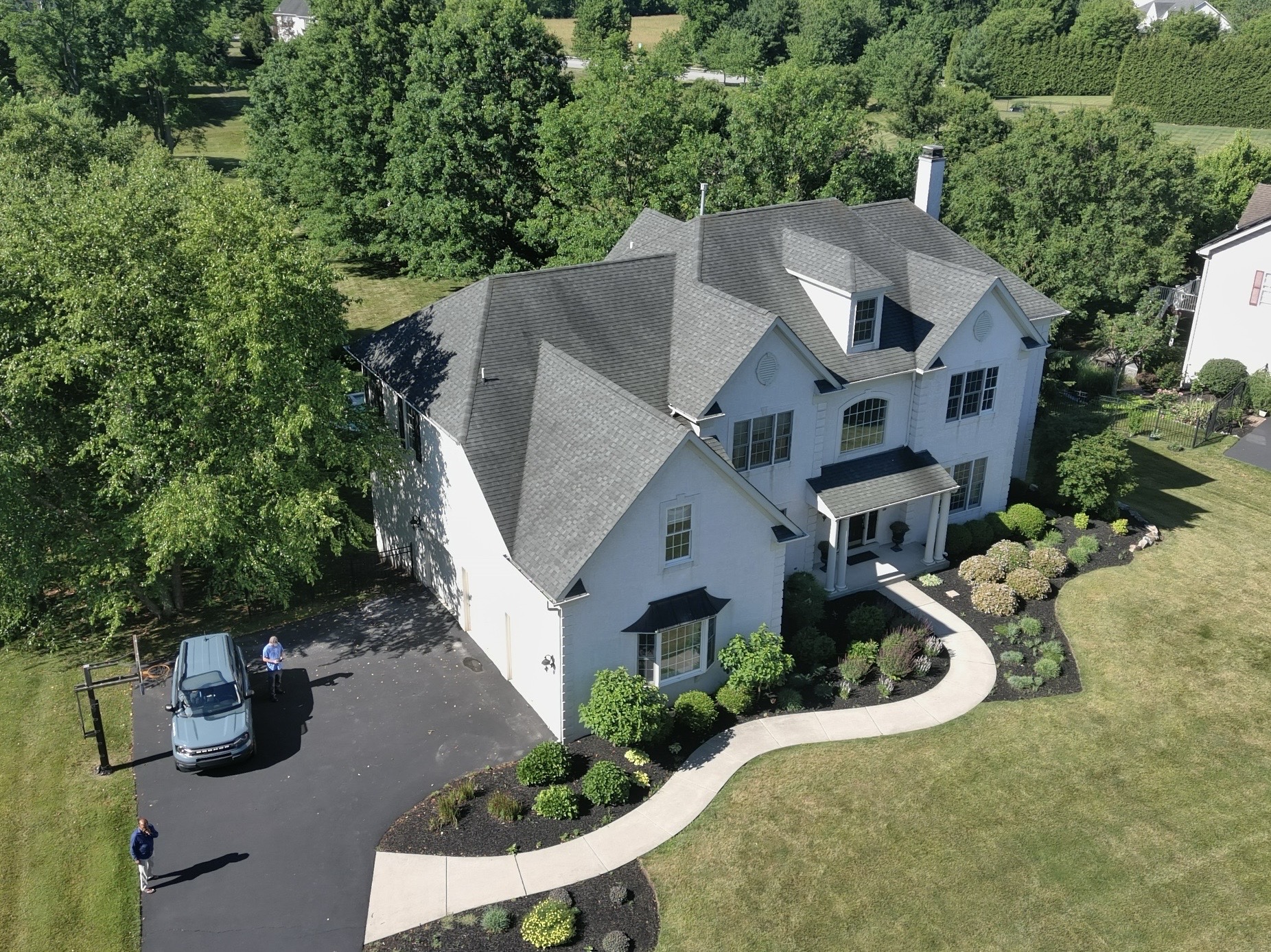 Aerial home inspection by Cory Shalaway — large painted-brick colonial estate with landscaped grounds in Royersford, Pennsylvania