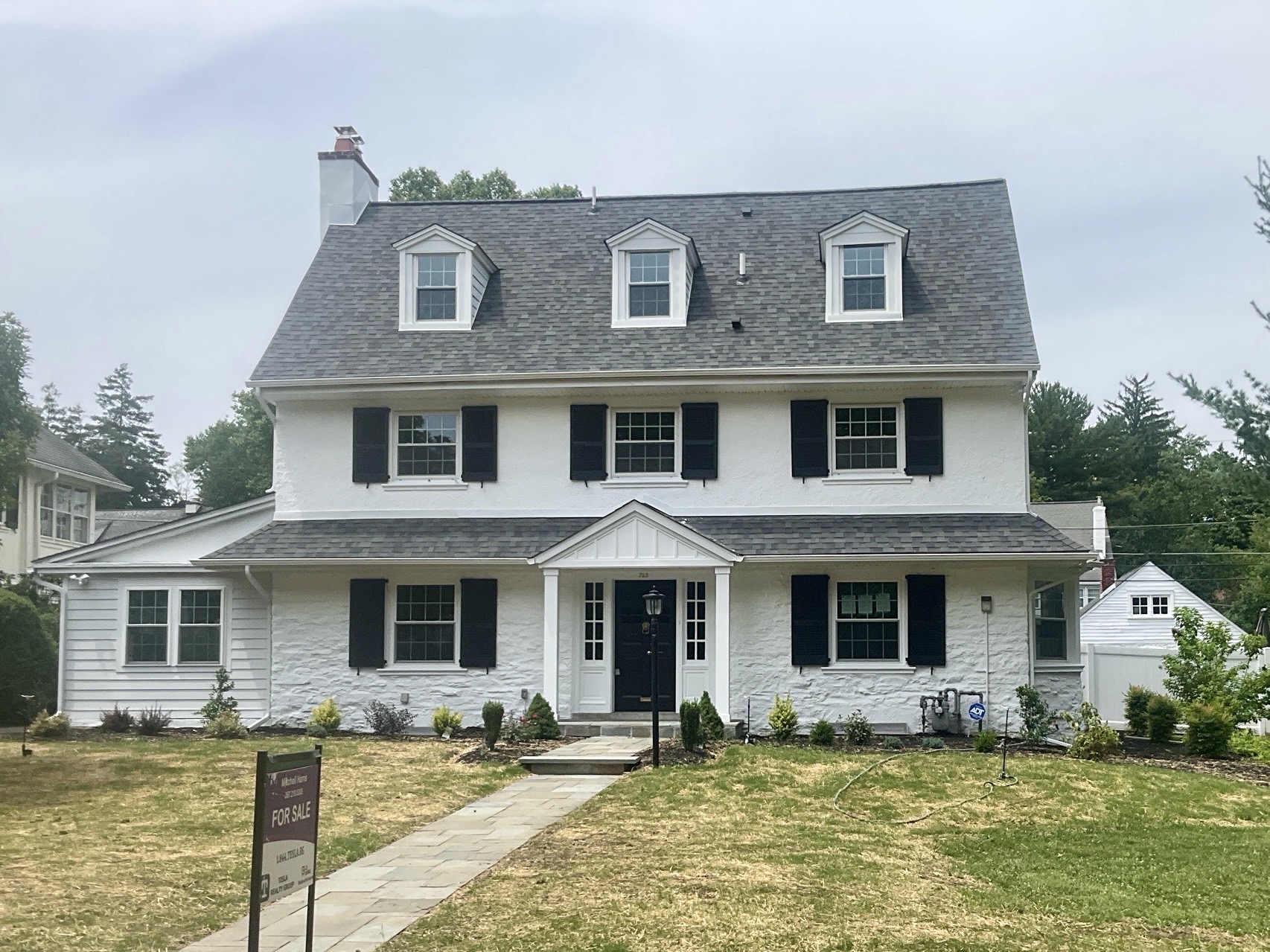 Home inspection by James Royer — white stucco Dutch Colonial with gambrel roof and dormers in Merion Station, Pennsylvania