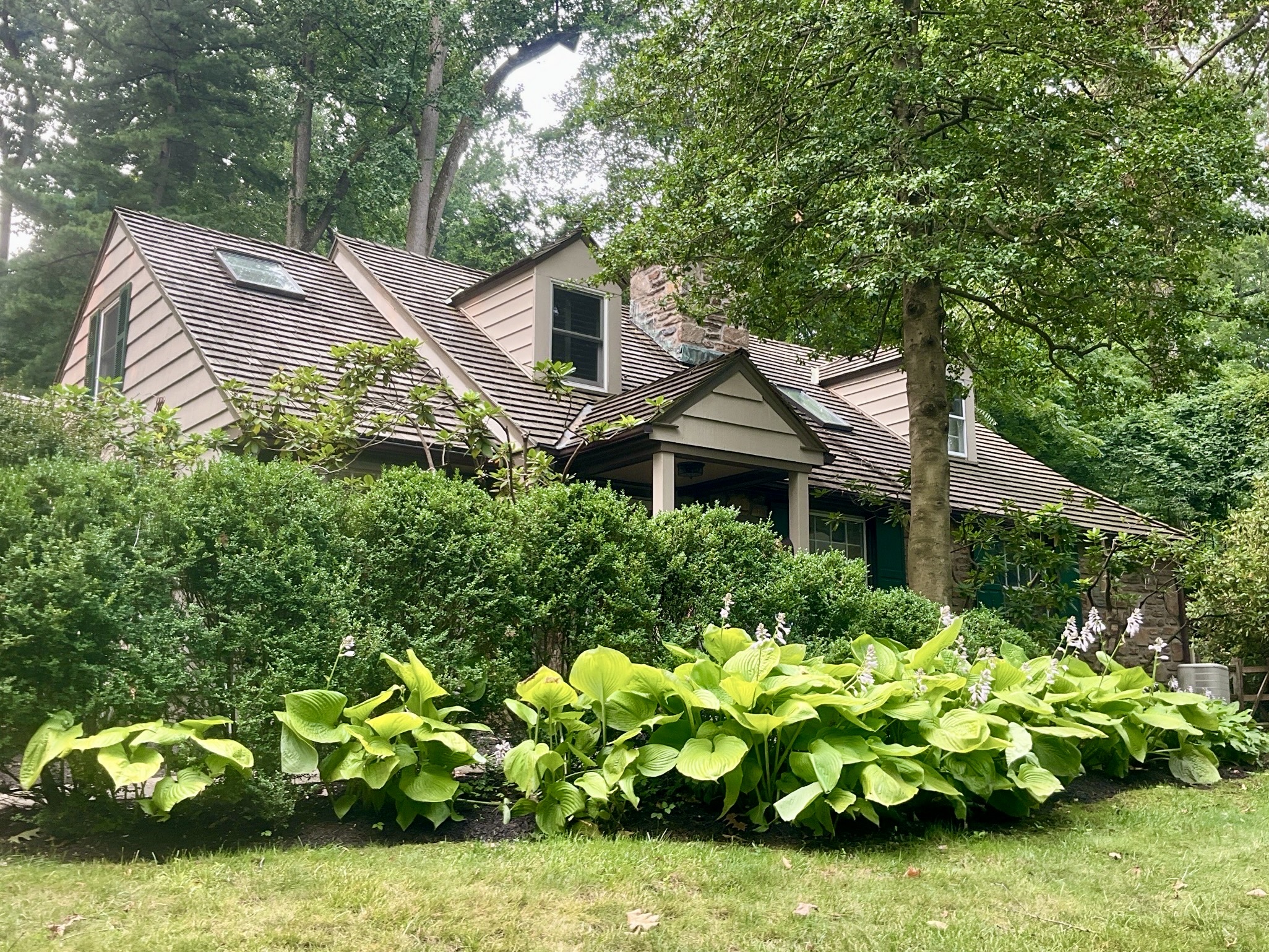 Home inspection by James Royer — storybook stucco cottage with cedar-shake roof and mature gardens in Bryn Mawr, Pennsylvania