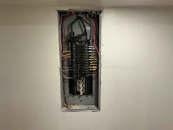 Open electrical service panel with the cover removed, missing AFCI protection