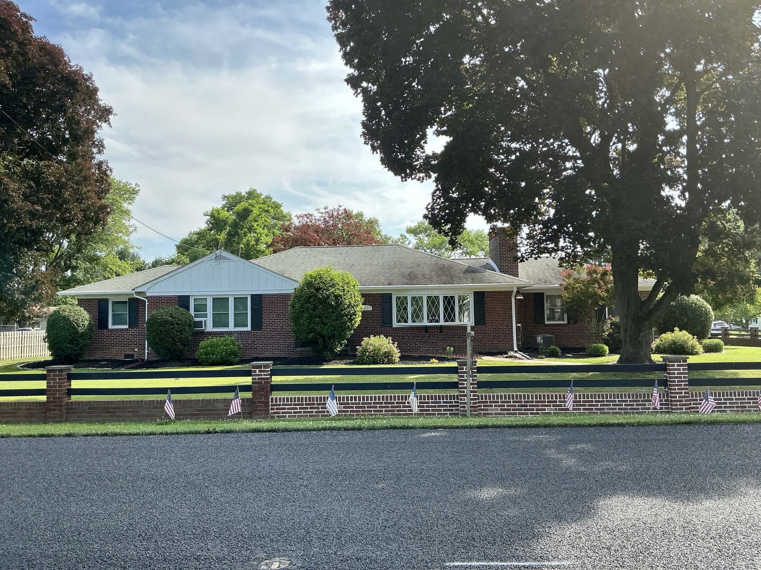 Home inspection by Steven Haslam — single-story brick ranch home with black shutters behind a brick fence in Boothwyn, Pennsylvania