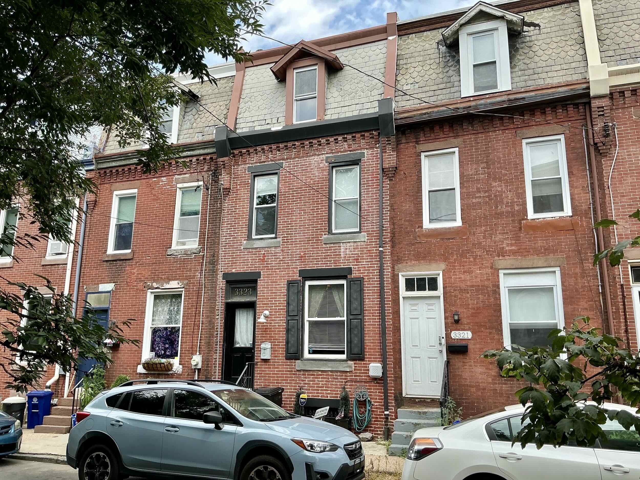 Home inspection by Steven Haslam — historic red-brick Victorian rowhome with mansard shingle roof and dormer in East Falls, Philadelphia
