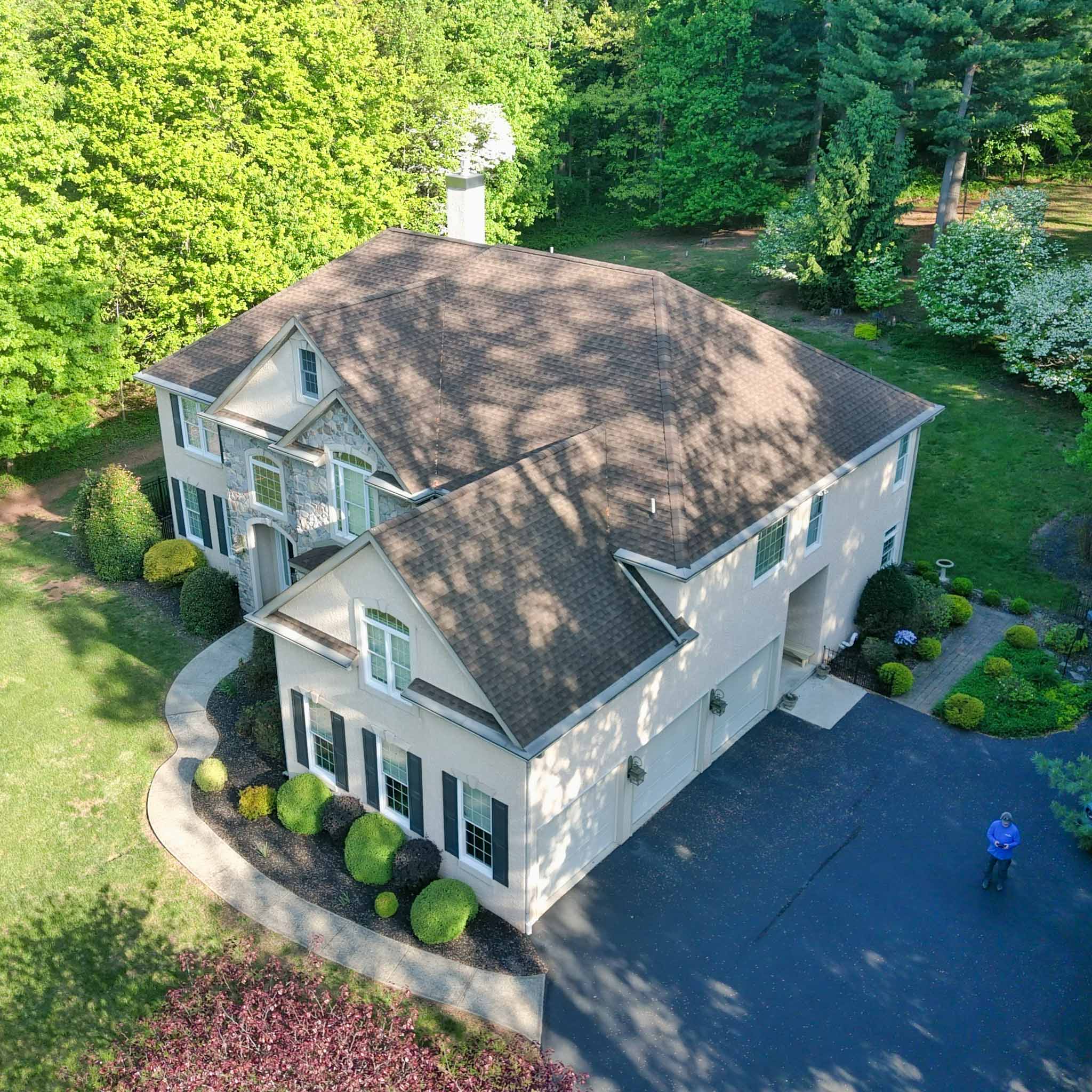 Aerial view of a large stucco-and-stone colonial on a landscaped lot in Pottstown, Berks County inspected by ValueGuard