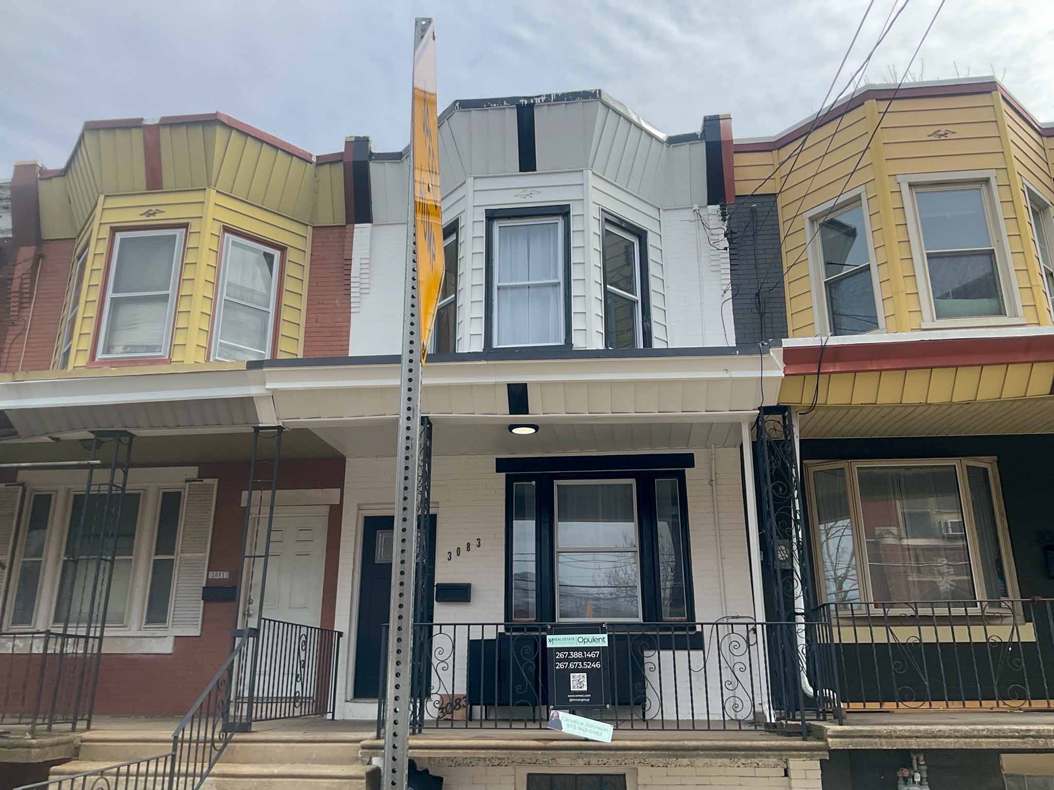 ValueGuard home inspection — refaced red-brick Port Richmond rowhome with oval leaded-glass door and modern transom