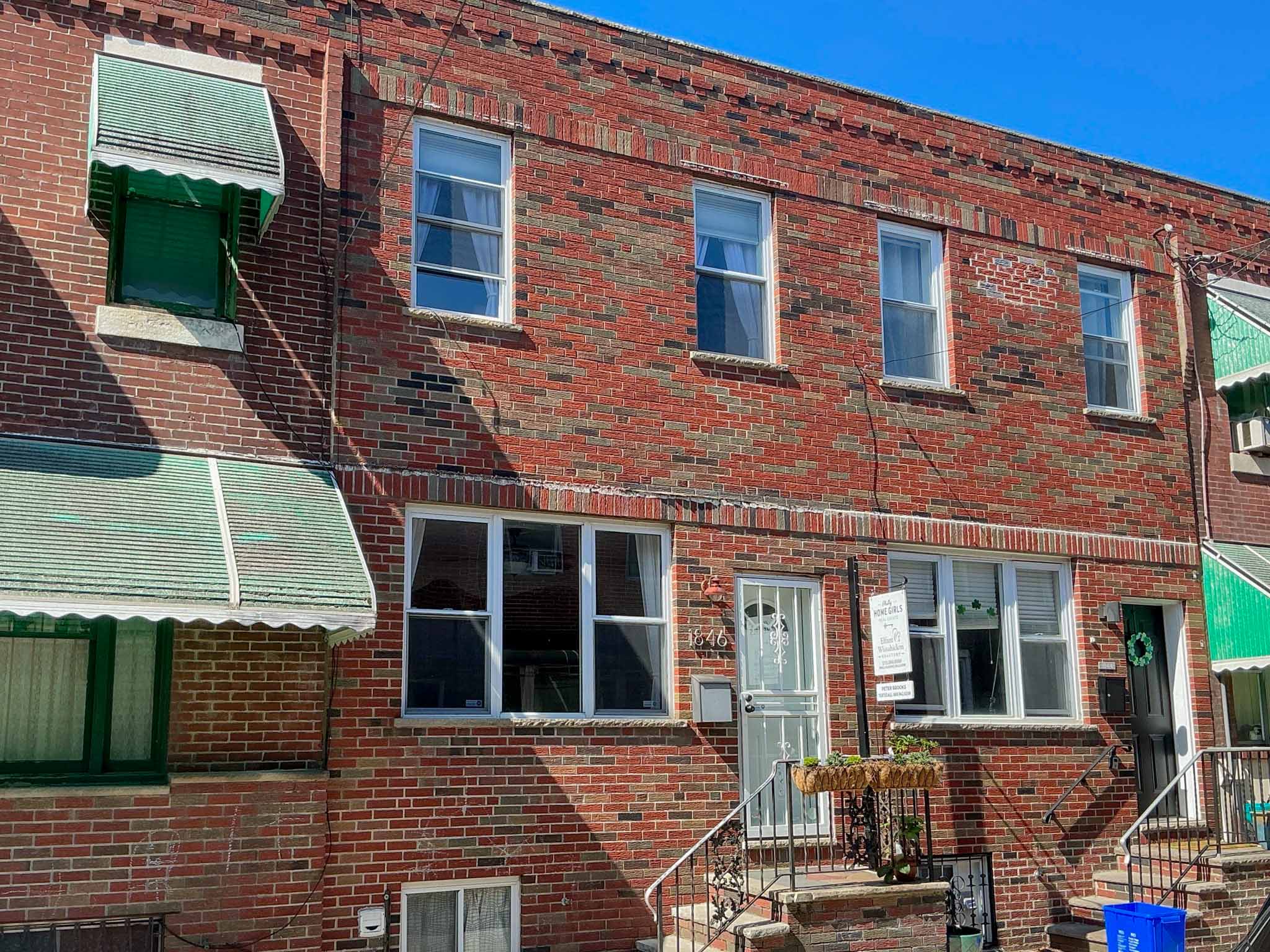 ValueGuard home inspection — classic porchless red brick rowhome with shoulder-height picture window in South Philadelphia