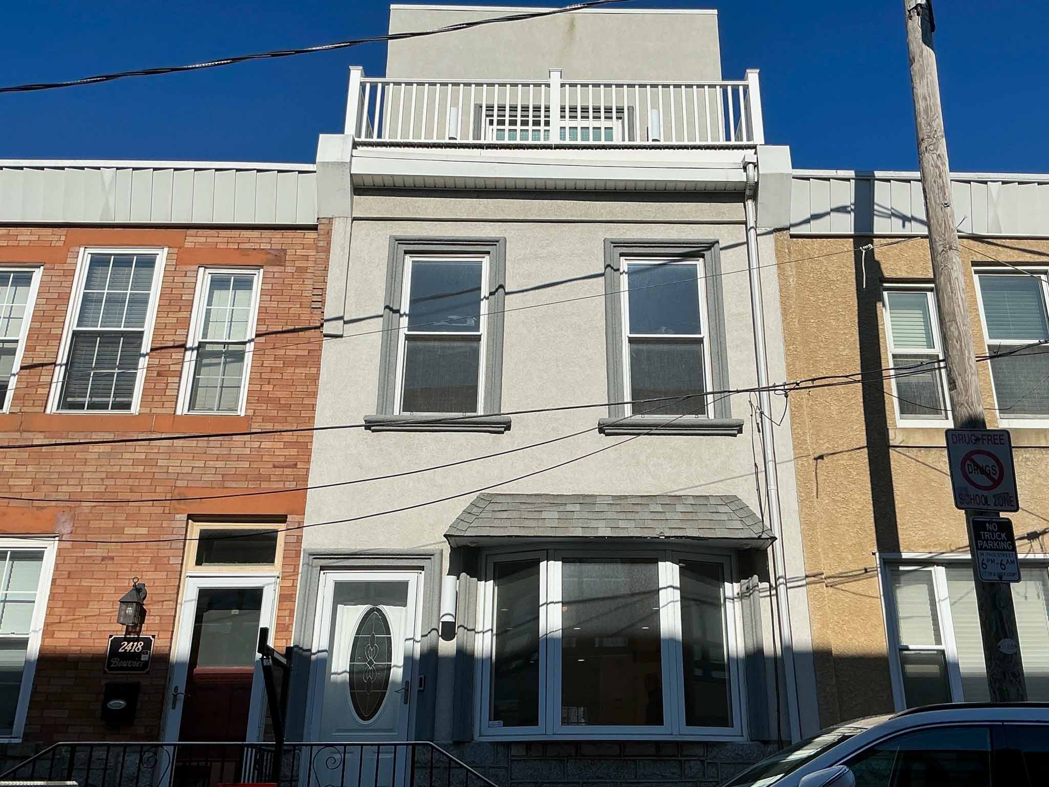 ValueGuard home inspection — stucco rowhome with modern third-floor pop-up addition and roof deck in South Philadelphia