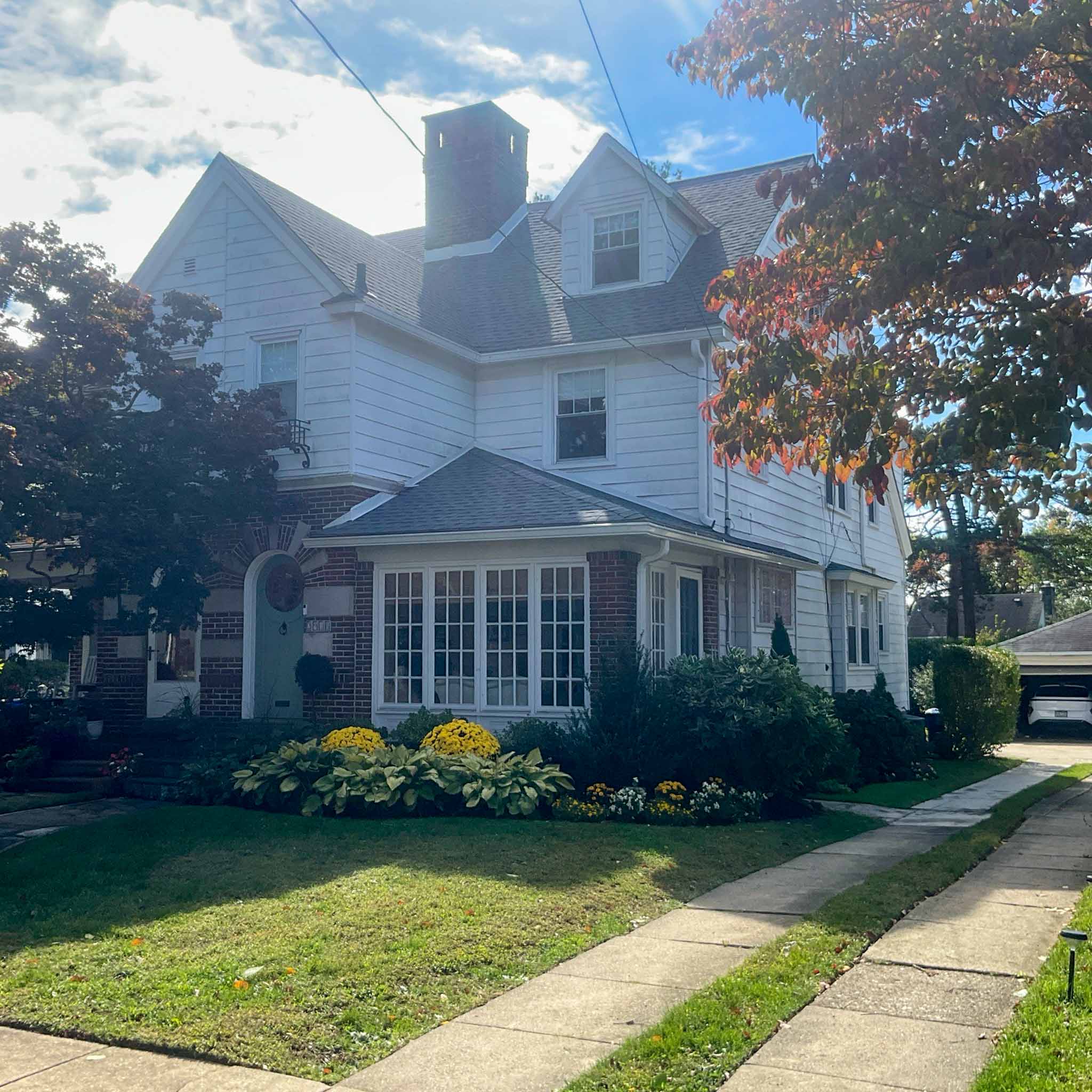 Ardmore Home Inspection — Victorian-Era Colonial Large white-clapboard Victorian and Colonial Revival home with brick first-floor accents and a front sunroom in Ardmore, Montgomery County PA, inspected by a ValueGuard home inspector