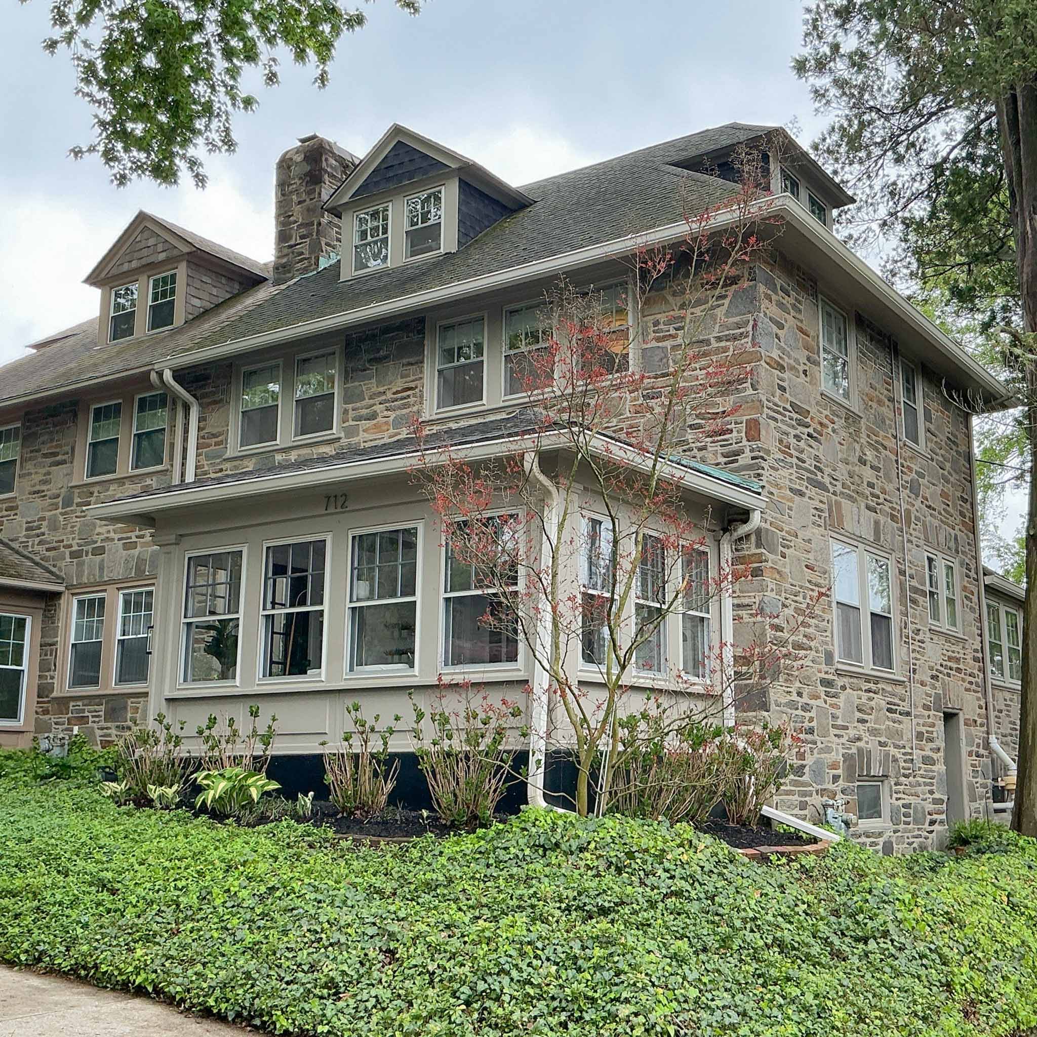 Large fieldstone Shingle-style Foursquare home with gambrel roof, dormers and enclosed sunporch in Bala Cynwyd inspected by a ValueGuard home inspector