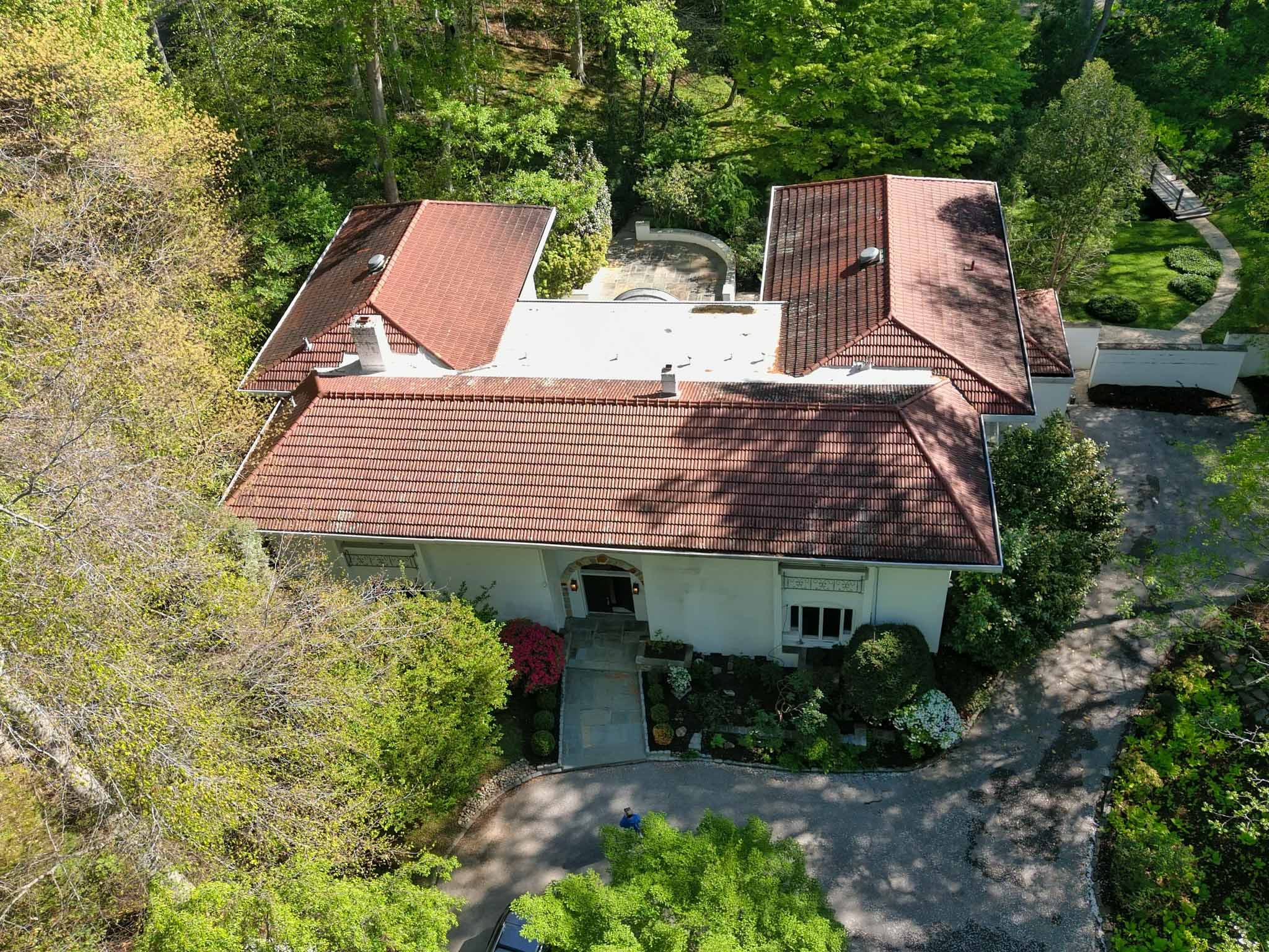 Grand Mediterranean stucco estate with a red clay-tile roof and circular drive in Bryn Mawr inspected by a ValueGuard home inspector