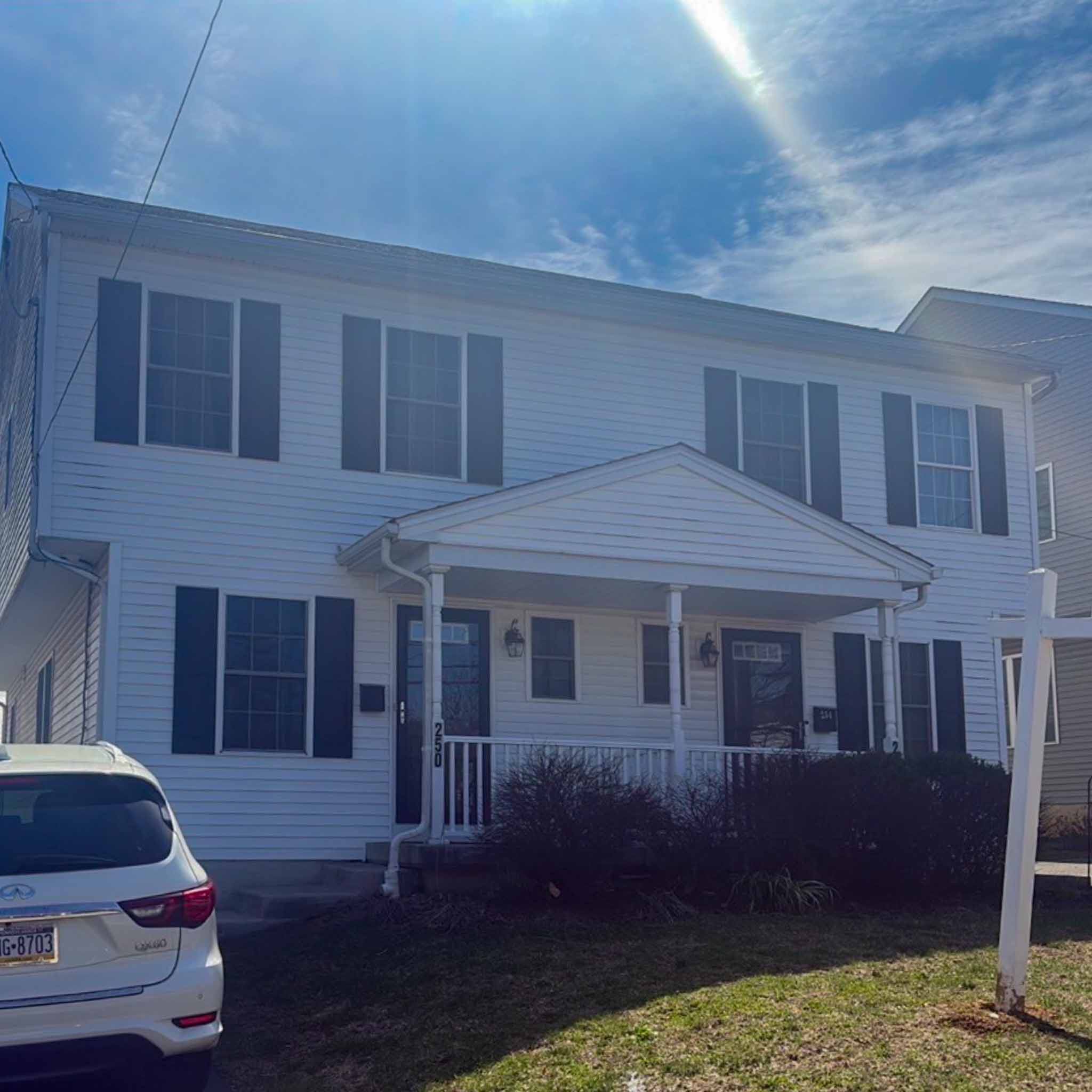 Newer white vinyl twin with gable porch portico in Clifton Heights inspected by ValueGuard