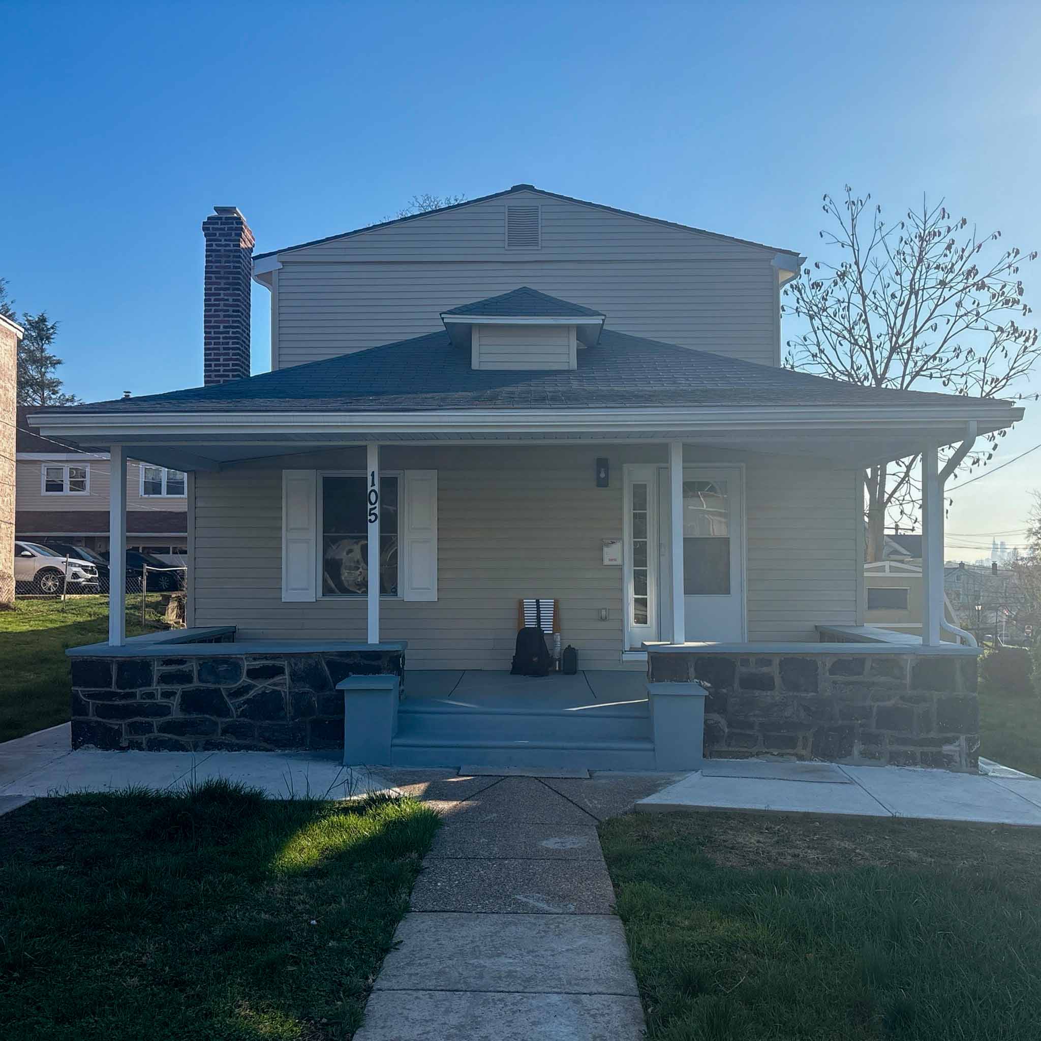 Tan Foursquare bungalow with wraparound porch in Clifton Heights inspected by ValueGuard home inspectors