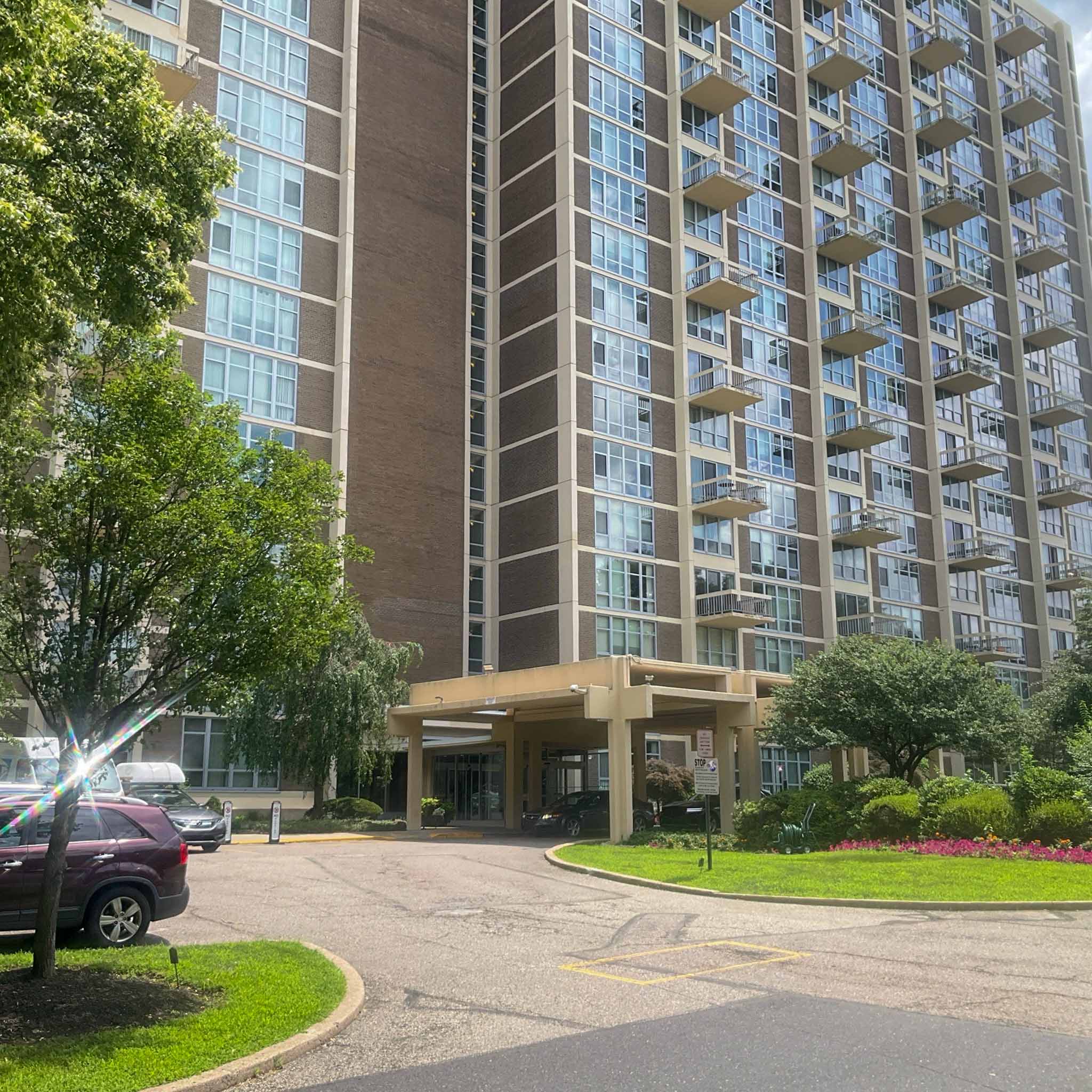 Brick condominium high-rise with balconies and a covered entry in Conshohocken inspected by ValueGuard home inspectors