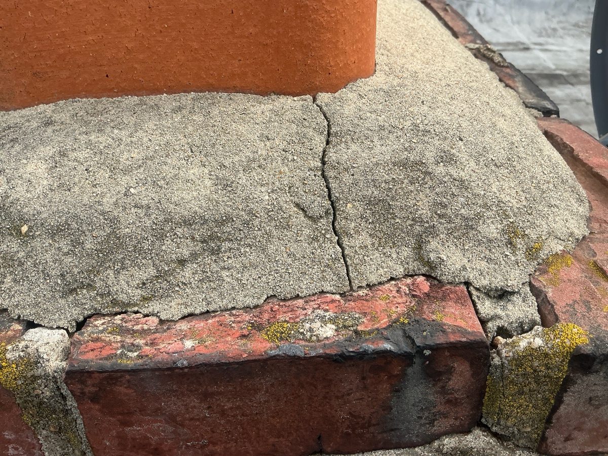 Cracked concrete chimney crown found during a fall home inspection in Greater Philadelphia