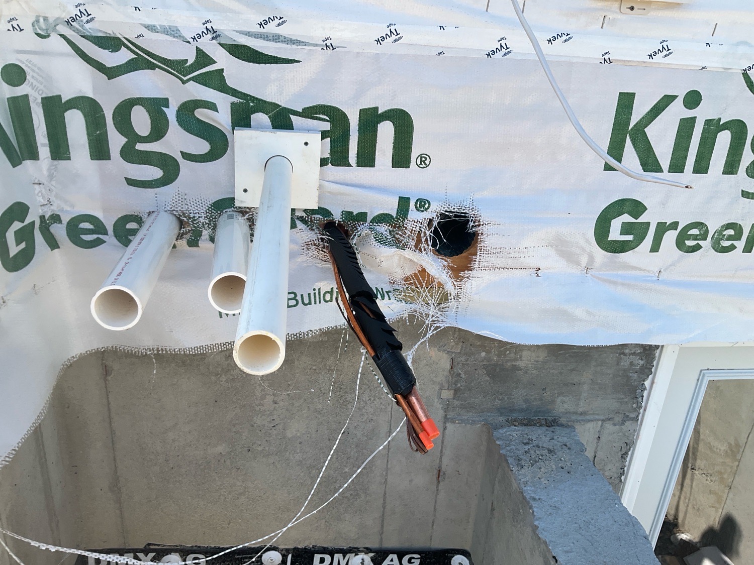 Torn house wrap around exterior penetrations exposing the wall sheathing, documented during a pre-drywall inspection