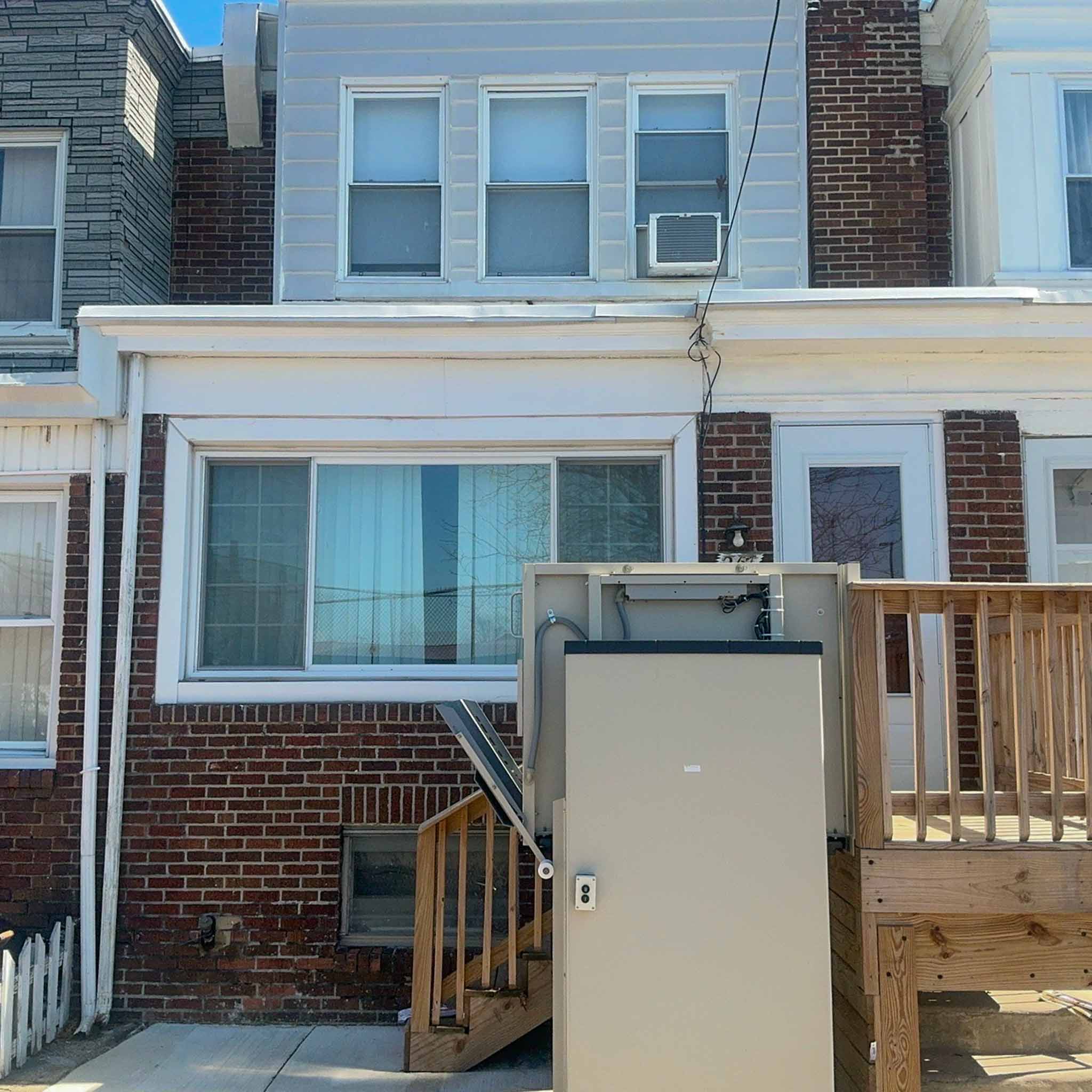Brick Darby row home with a bay window and a rebuilt rear wood deck inspected by a ValueGuard home inspector