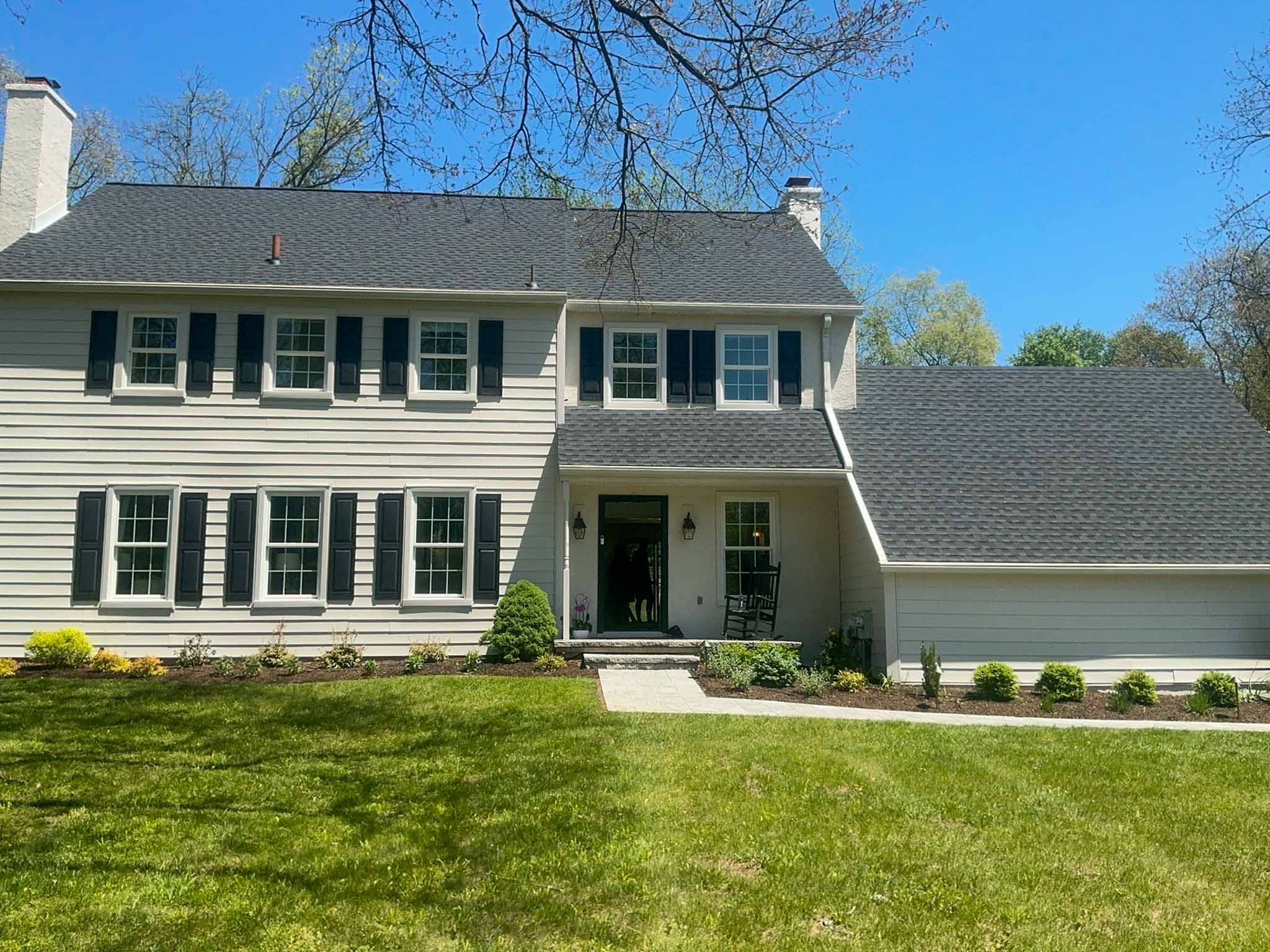 Devon Home Inspection — Updated Main Line Colonial Updated older Main Line colonial with pale clapboard siding, black shutters and mature landscaping in Devon, Chester County PA, inspected by ValueGuard home inspectors