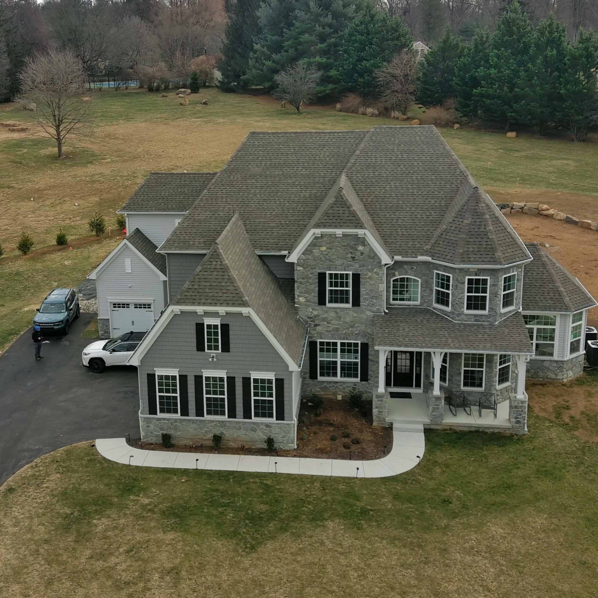 Devon Home Inspection — New-Construction Estate Premium new-construction stone-and-shake estate home on a large wooded lot in Devon, Chester County PA, inspected by a ValueGuard home inspector