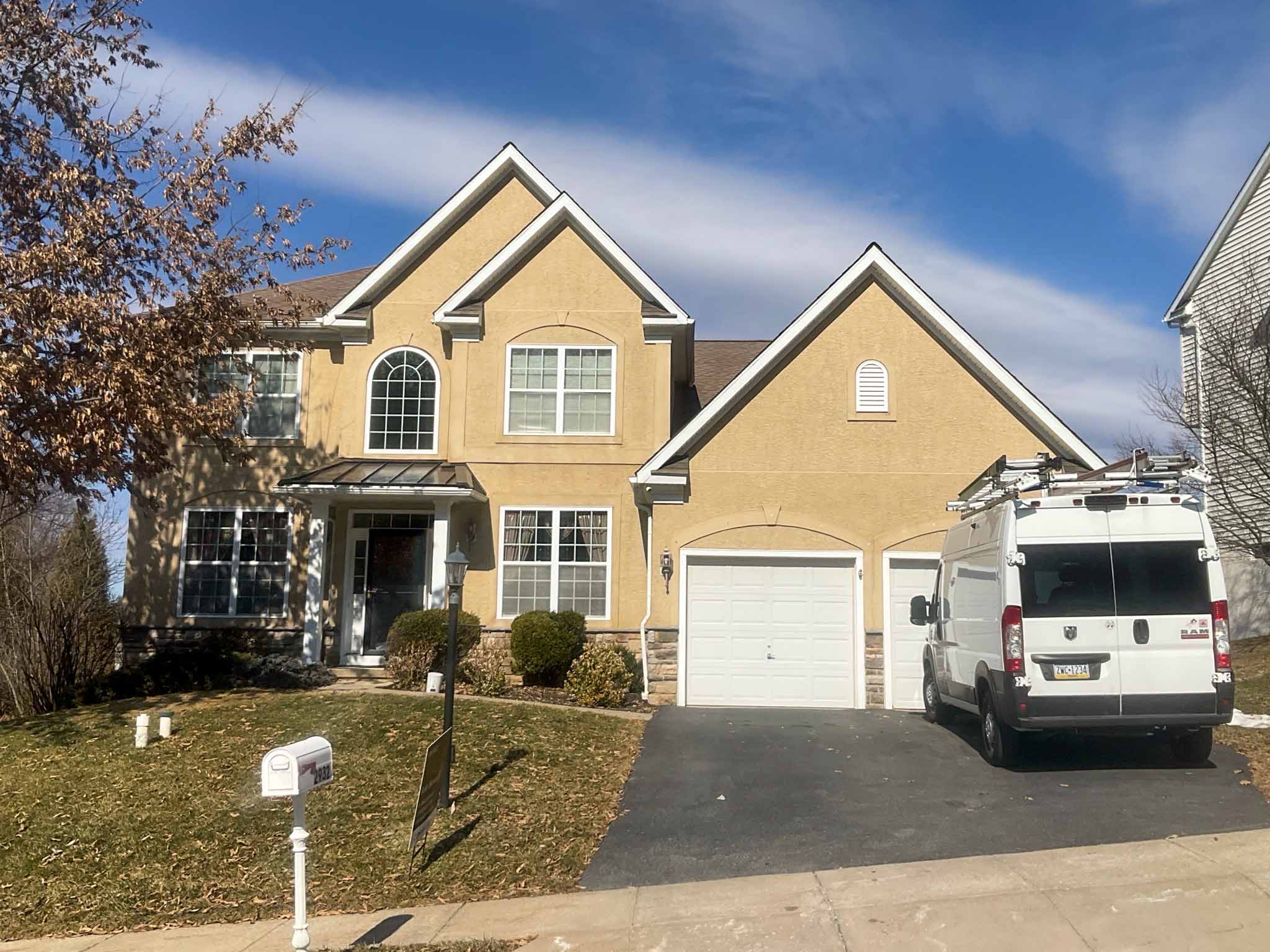 Attached townhome with stucco lower facade, vinyl siding above and a mansard shingle roof in a Downingtown townhome community, Chester County PA, inspected by a ValueGuard home inspector