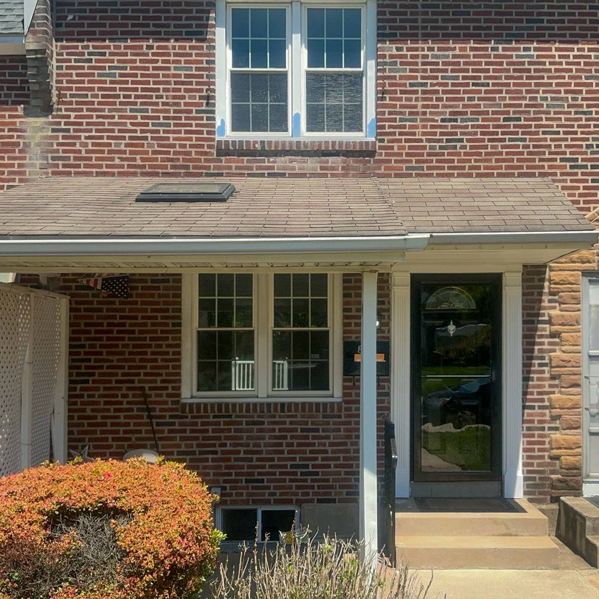 Red brick Drexel Hill twin with a covered front porch inspected by a ValueGuard home inspector