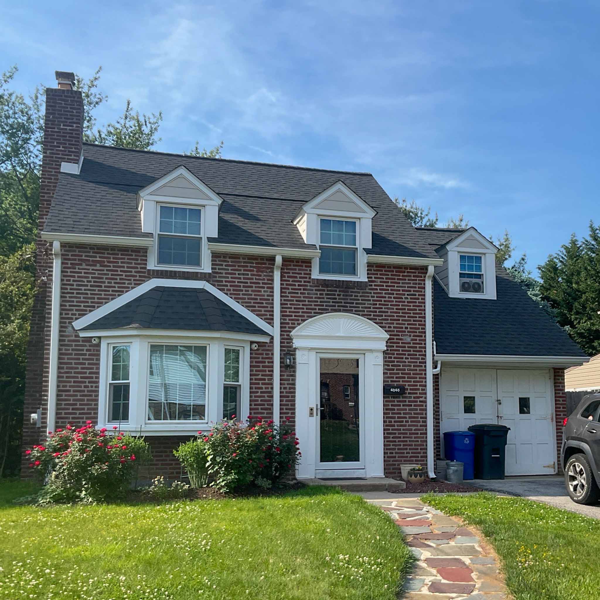 Mid-century red brick Drexel Hill colonial with dormers, bay window and attached garage inspected by ValueGuard