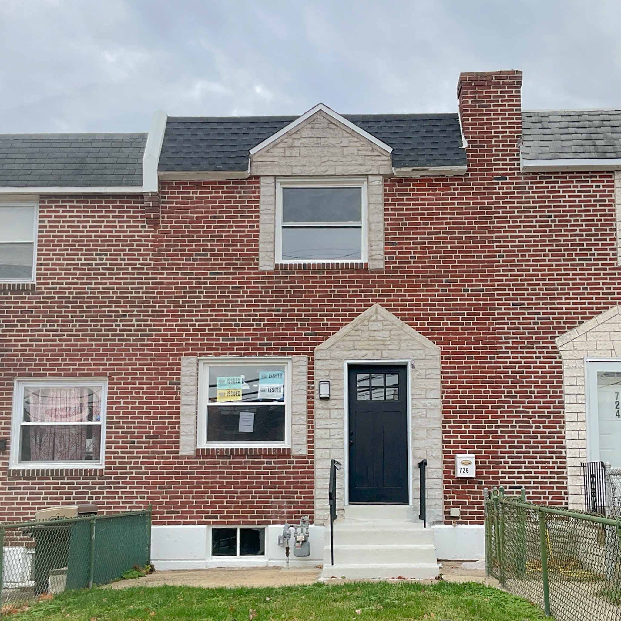 Freshly renovated Folcroft brick rowhome with permit notices and a new craftsman door inspected by a ValueGuard home inspector