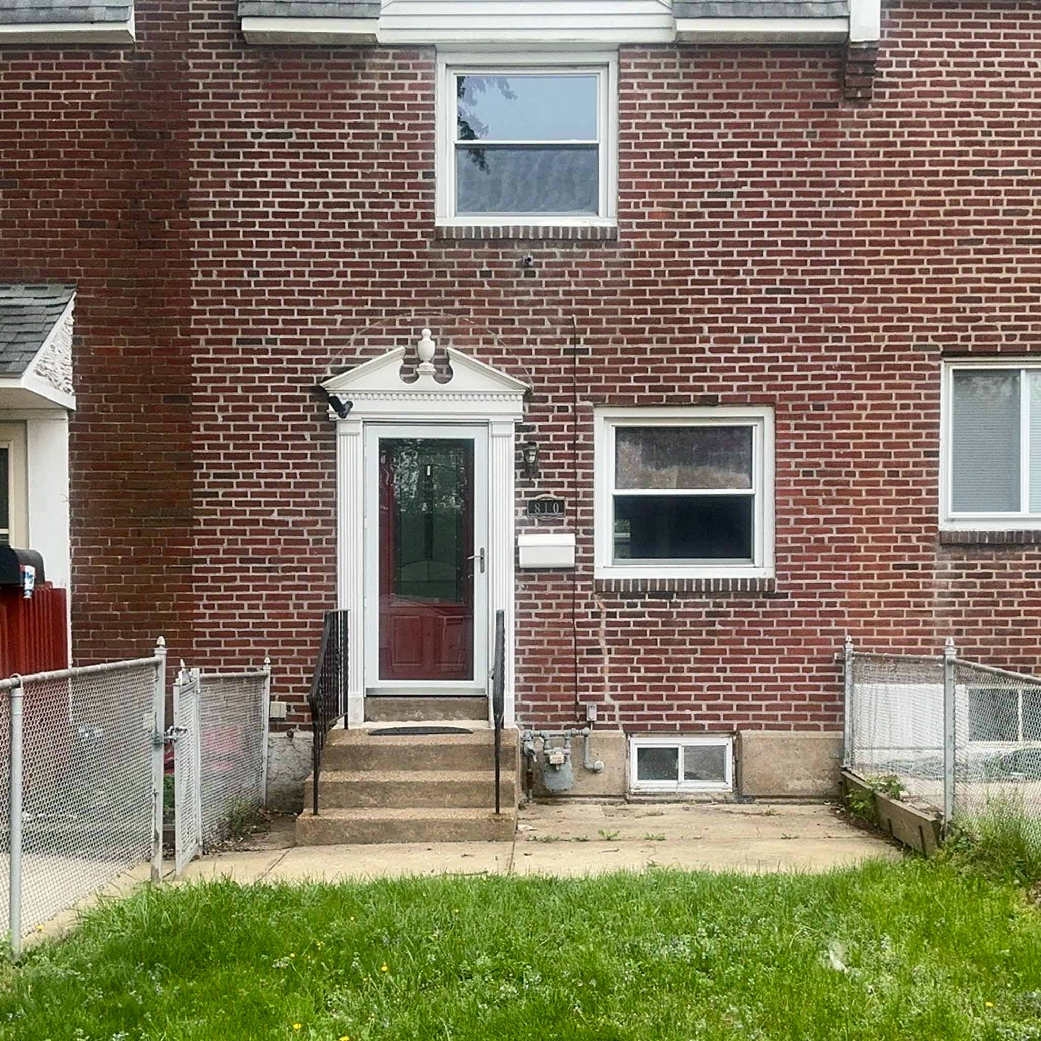 Original Folcroft brick rowhome with a pedimented entry surround inspected by ValueGuard