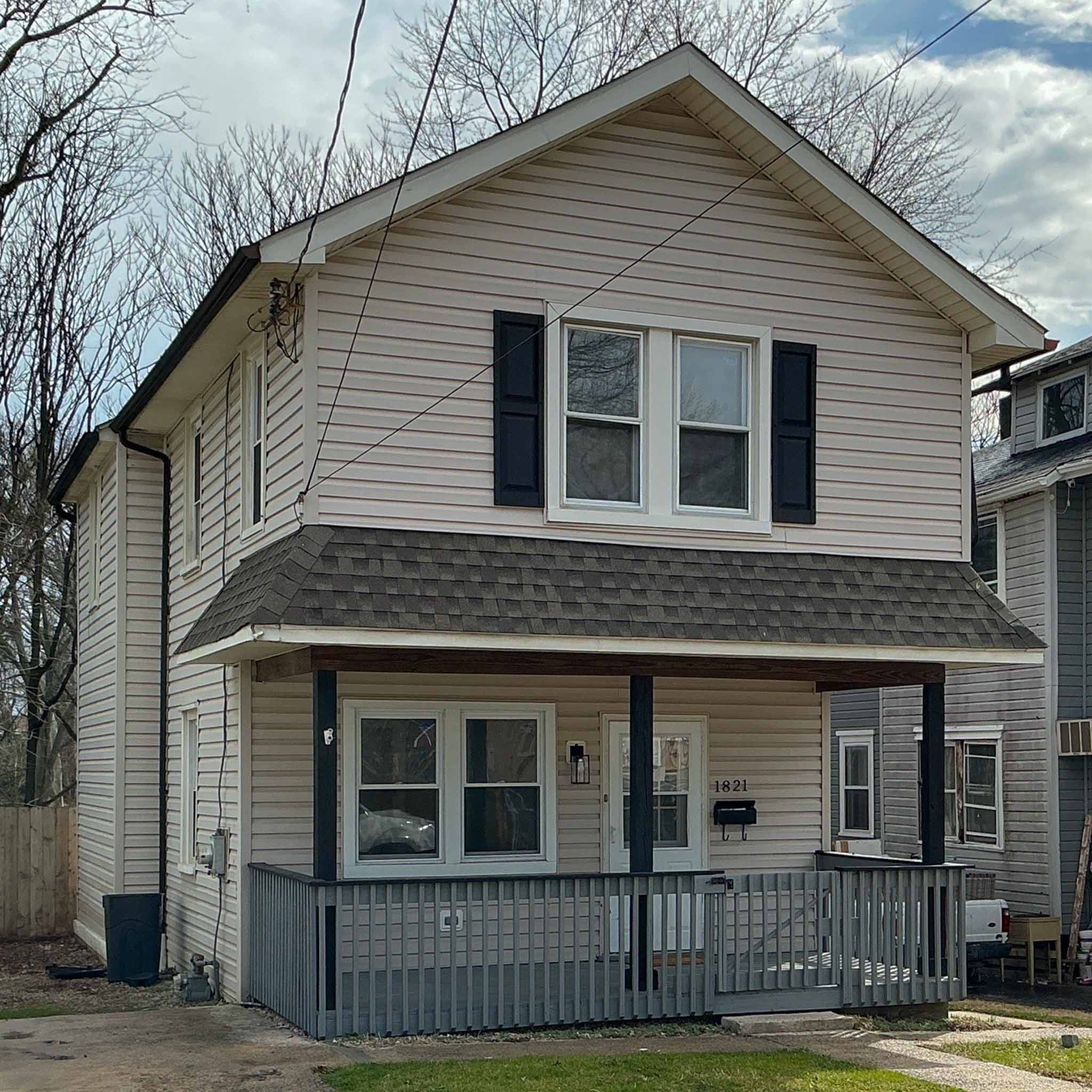 Tan vinyl-sided Folcroft frame home with a full front porch inspected by ValueGuard home inspectors