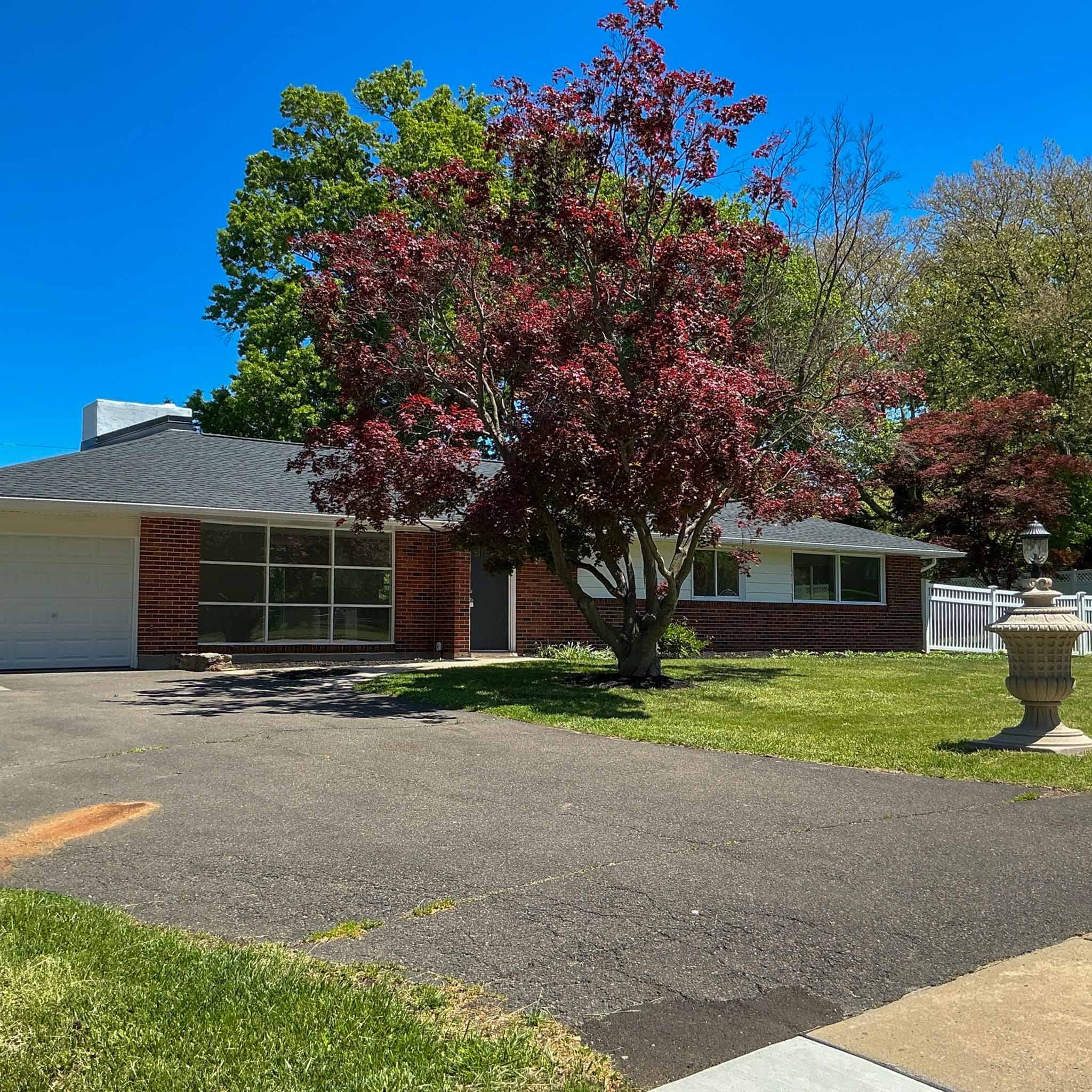 Long low mid-century Glenside brick ranch with a picture window and attached garage inspected by a ValueGuard home inspector