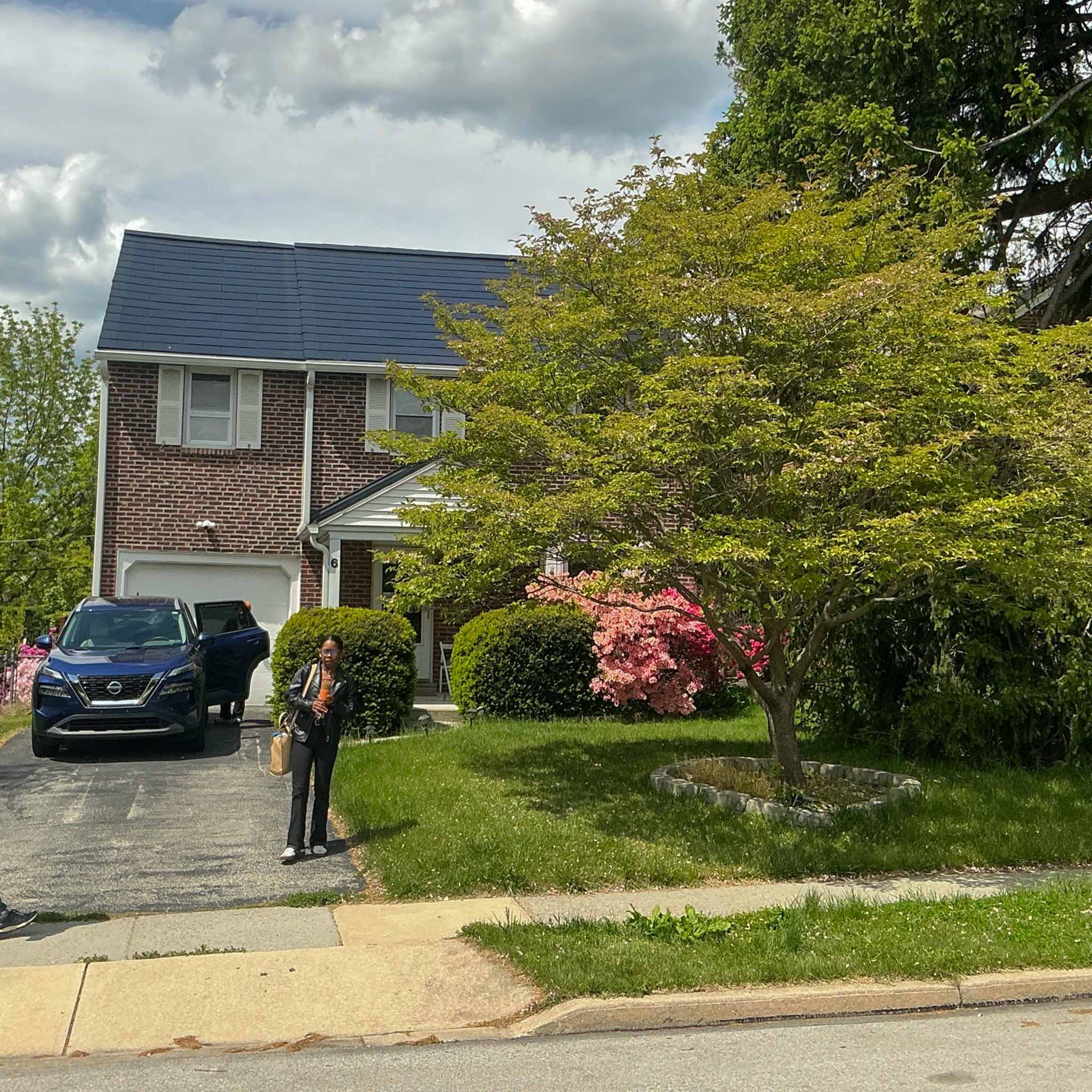Brick Havertown colonial with a full solar-shingle roof and attached garage inspected by a ValueGuard home inspector