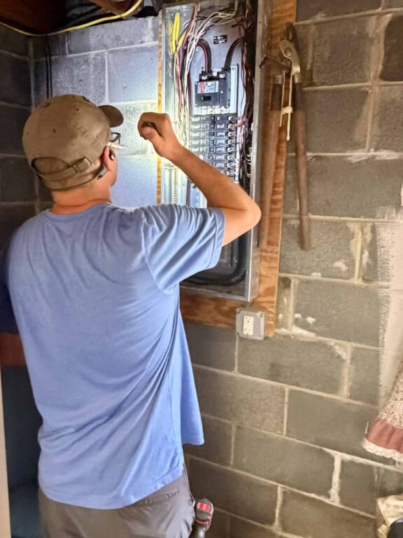 ValueGuard inspector Cory Shalaway inspecting the main electrical panel during a Philadelphia pre-listing inspection
