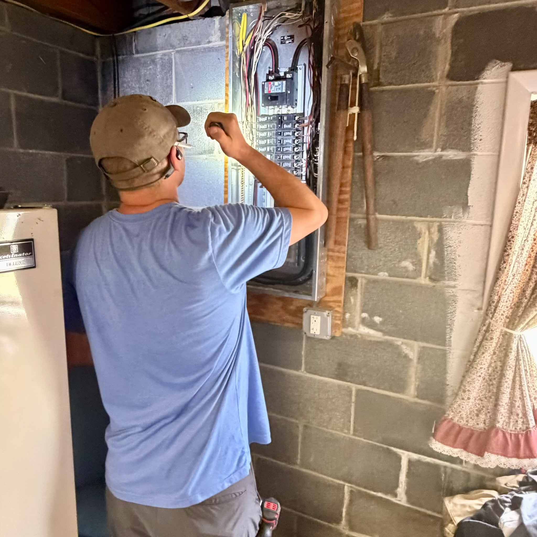 ValueGuard inspector Cory Shalaway inspecting the main electrical panel during a Philadelphia pre-listing inspection