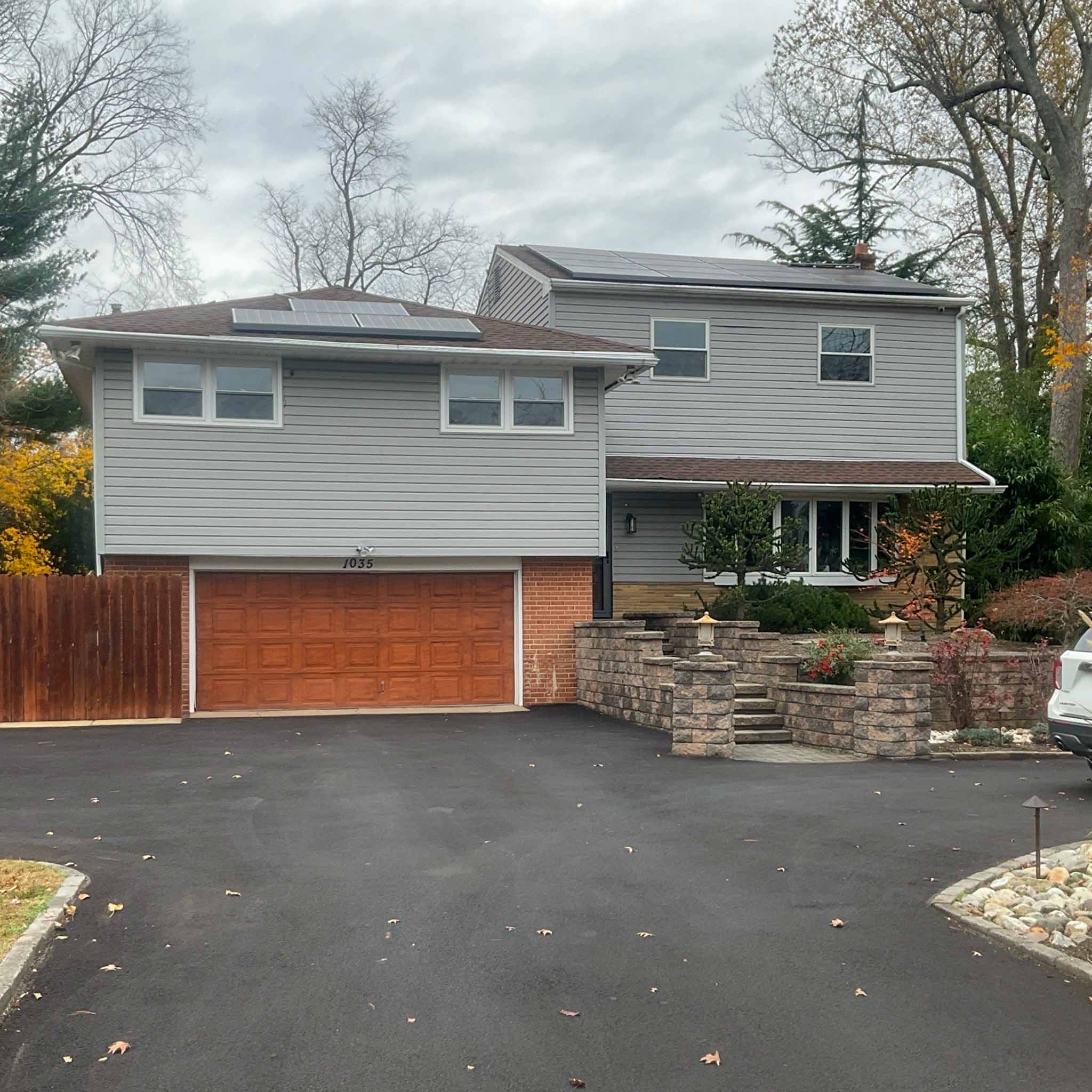 Jenkintown Home Inspection — Renovated Split-Level with Solar Renovated mid-century Jenkintown split-level with vinyl siding, brick accents and rooftop solar panels inspected by ValueGuard home inspectors