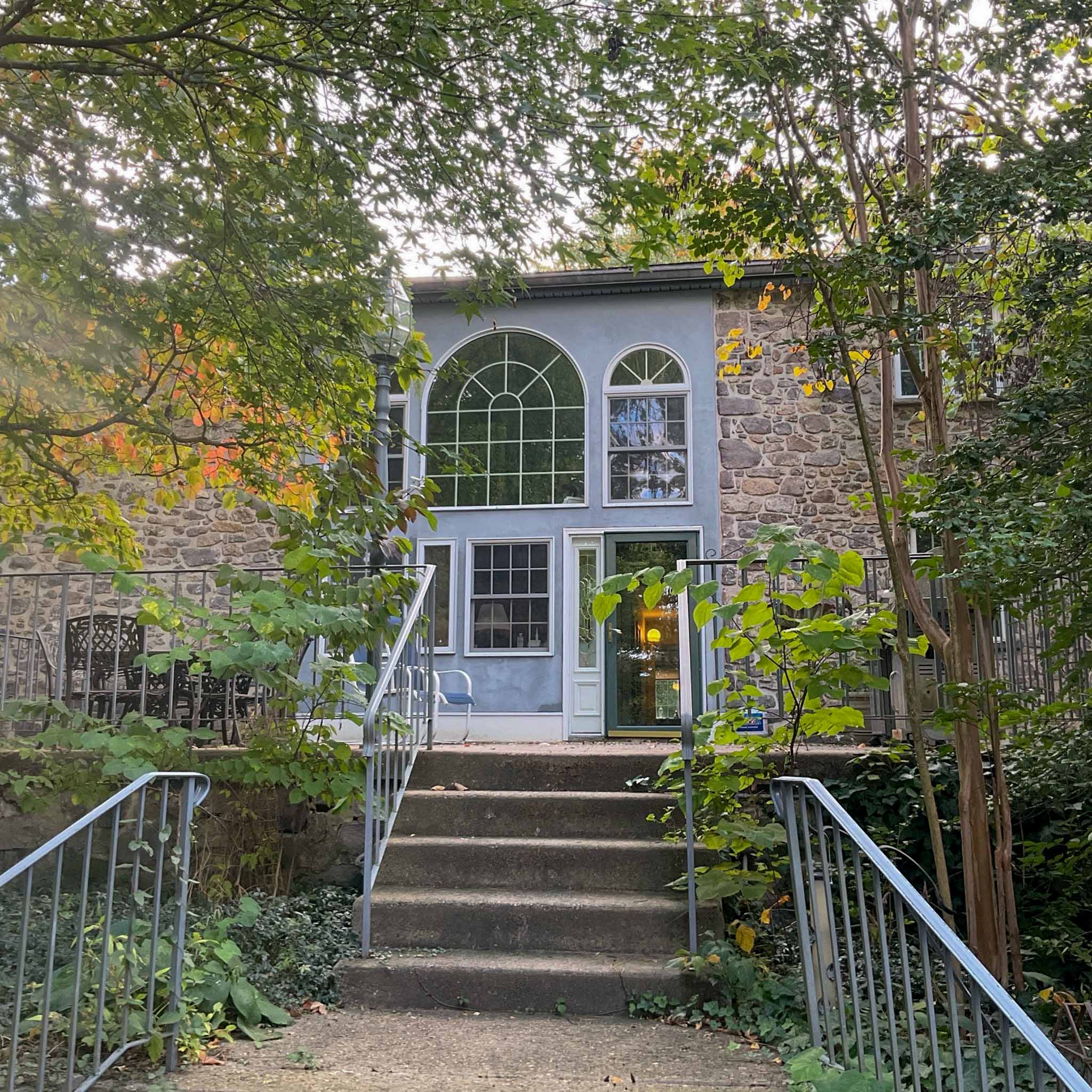 Older stone home in King of Prussia, PA with a large arched Palladian window, inspected by a ValueGuard home inspector