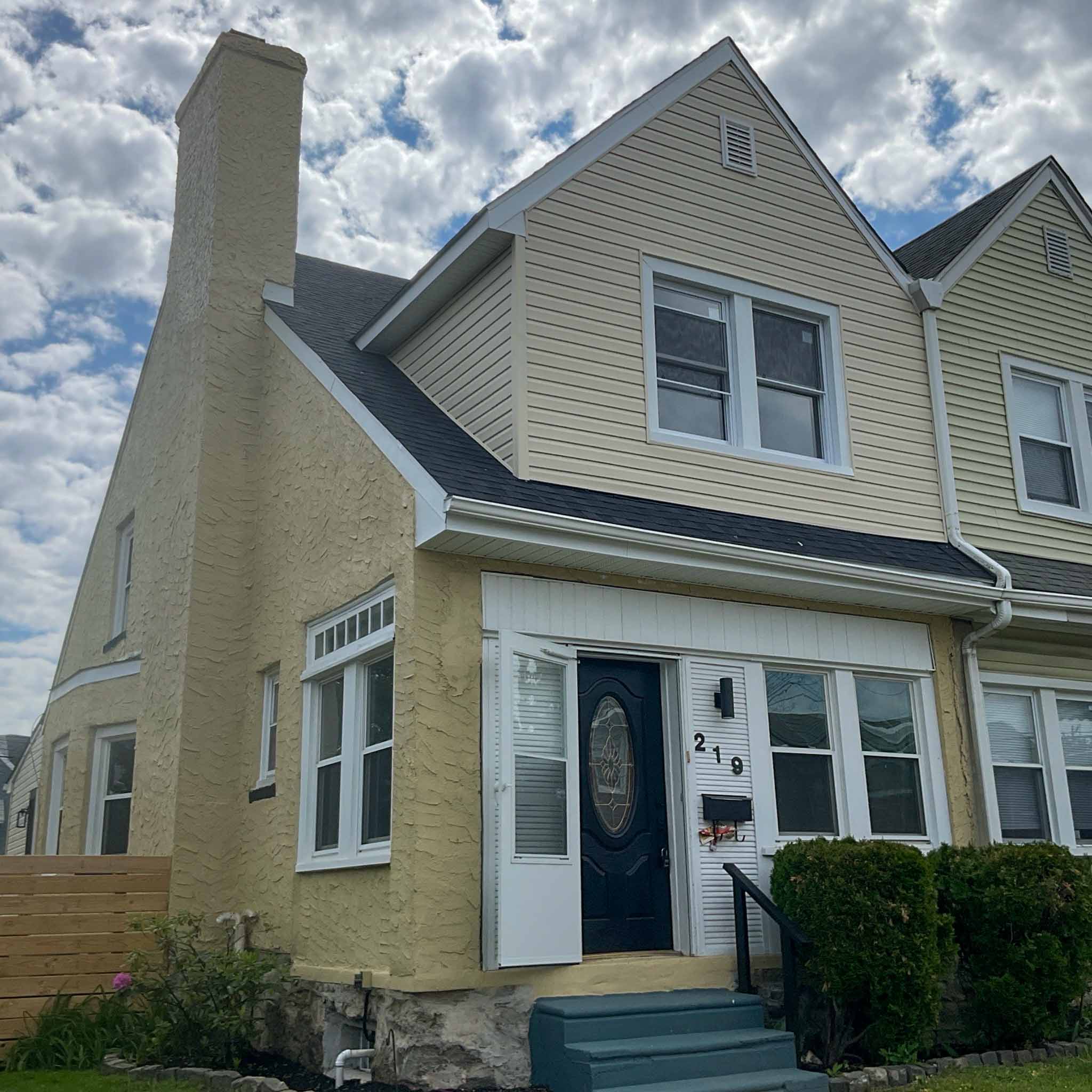 Stucco-and-vinyl steep-gable Lansdowne twin with enclosed front entry inspected by a ValueGuard home inspector