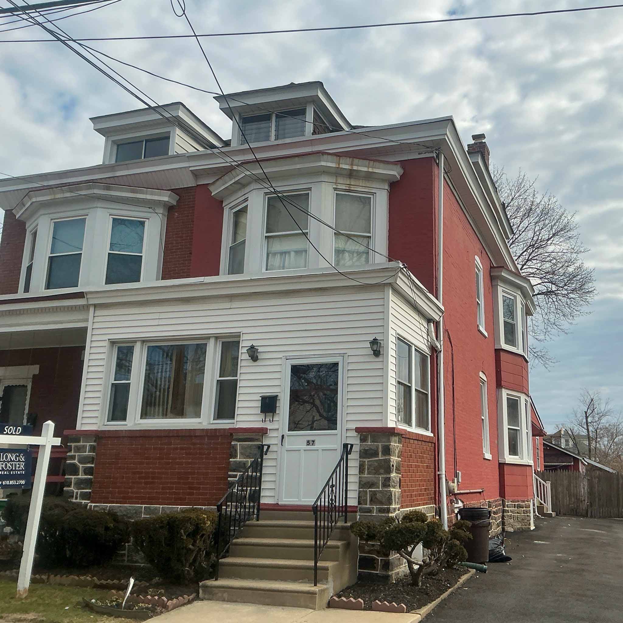 Red brick Victorian Foursquare twin with dormers in Lansdowne inspected by ValueGuard home inspectors