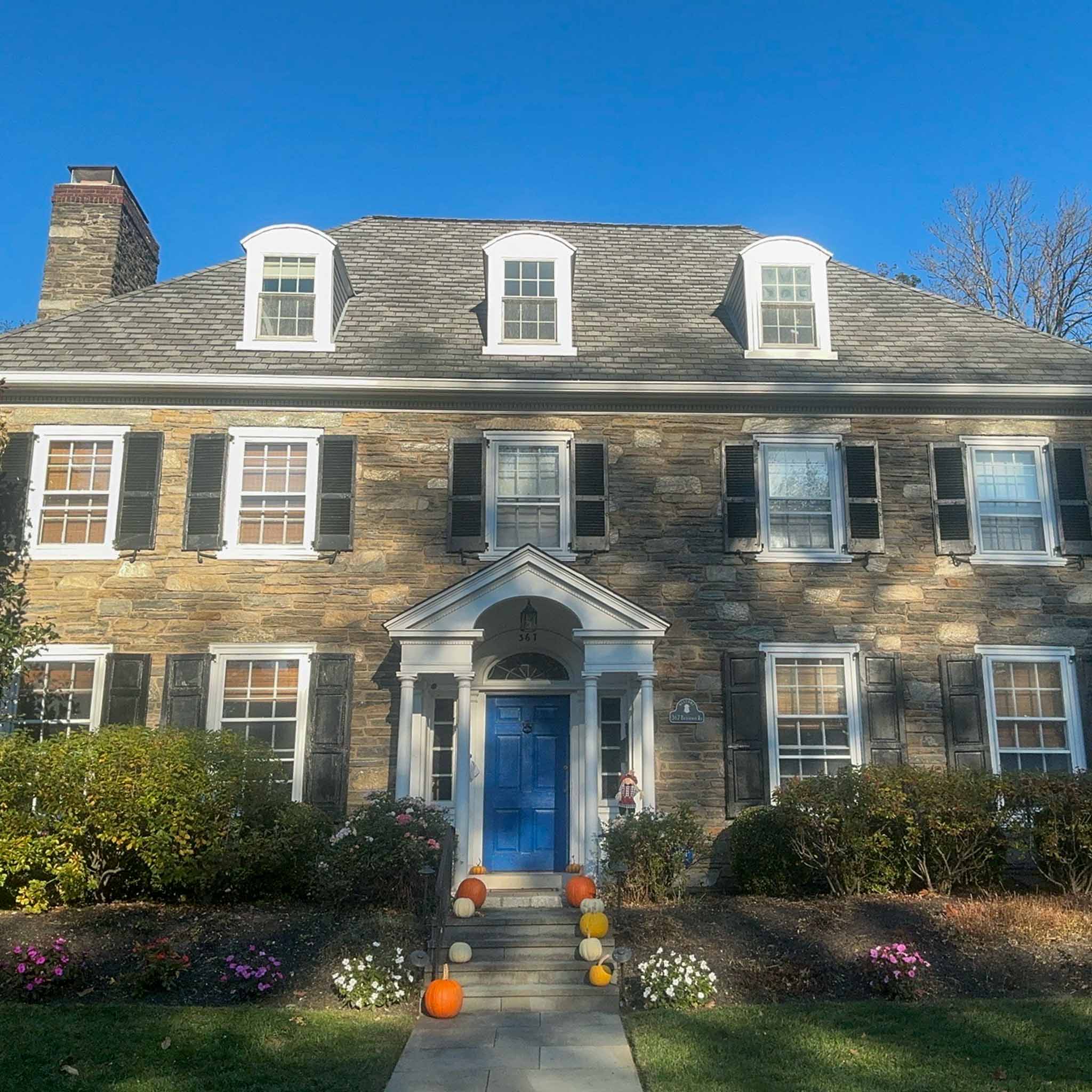 Grand stone Georgian colonial with arched dormers and a pedimented portico in Merion Station inspected by a ValueGuard home inspector