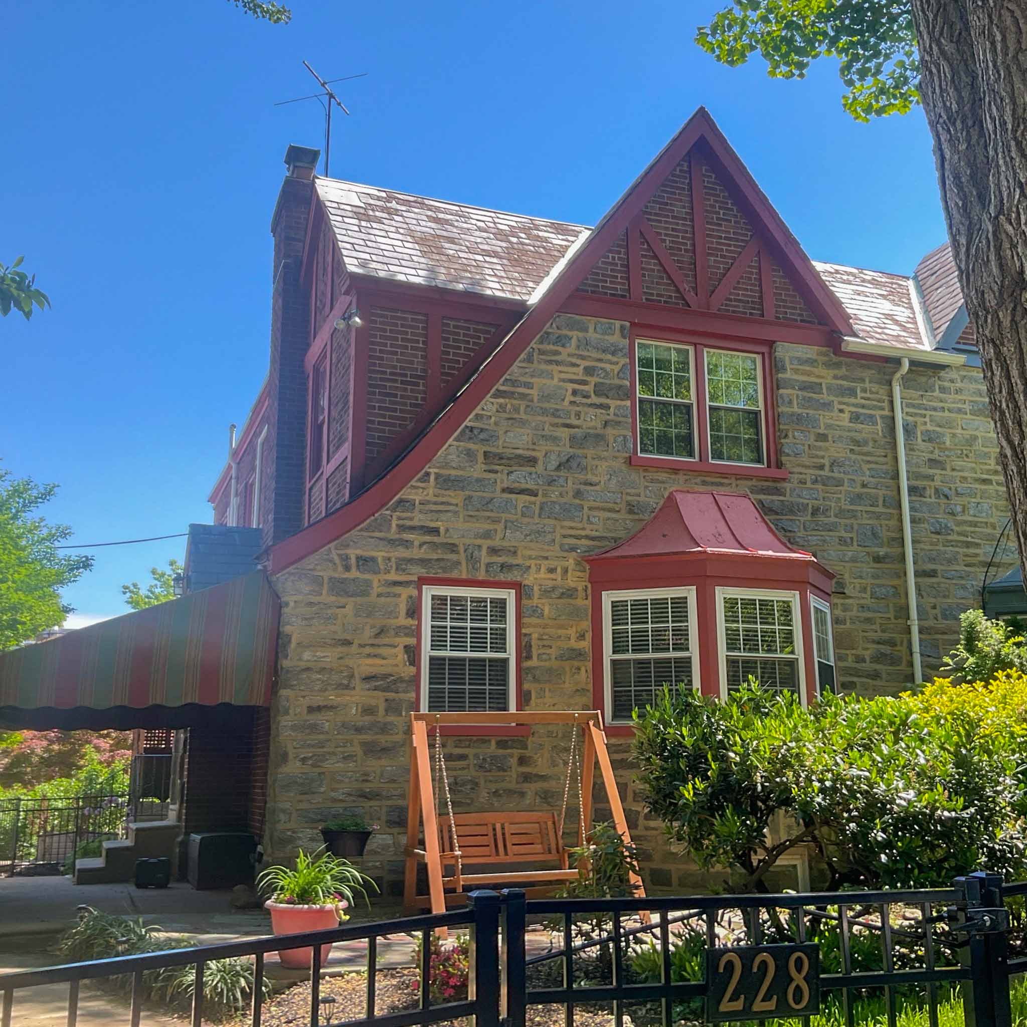 Stone-and-brick Tudor revival home with half-timbered gable and slate roof in Merion Station inspected by ValueGuard home inspectors