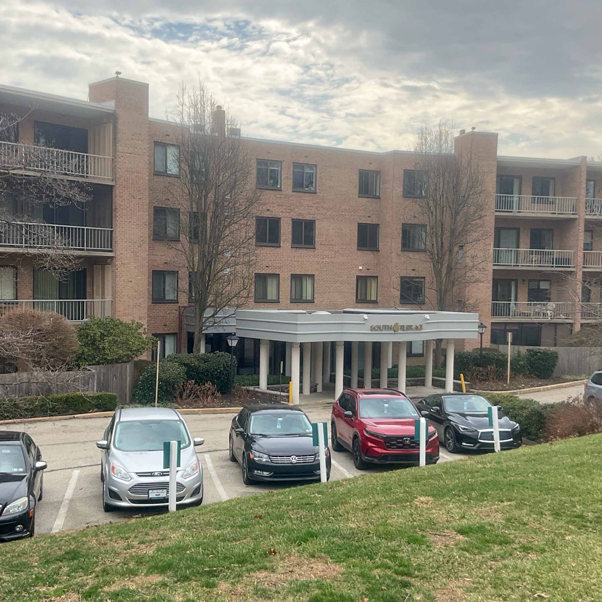 Brick mid-century condominium building with balconies and a covered entry near Narberth inspected by ValueGuard
