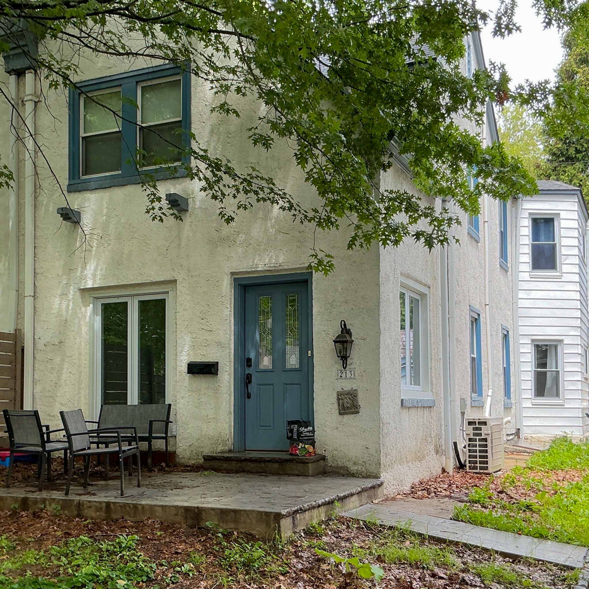 Stucco Borough twin home with a teal leaded-glass front door in Narberth inspected by ValueGuard home inspectors