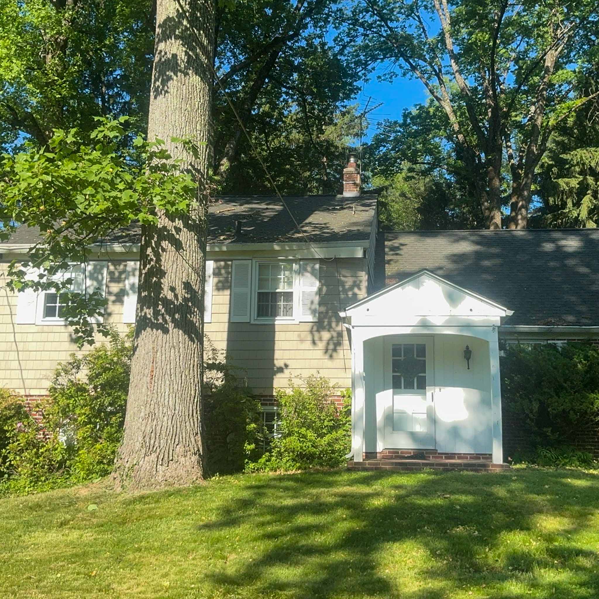 Newtown Square Home Inspection — Mid-Century Split-Level Mid-century cedar-shake split-level home with a white gabled door portico under mature trees in Newtown Square inspected by a ValueGuard home inspector