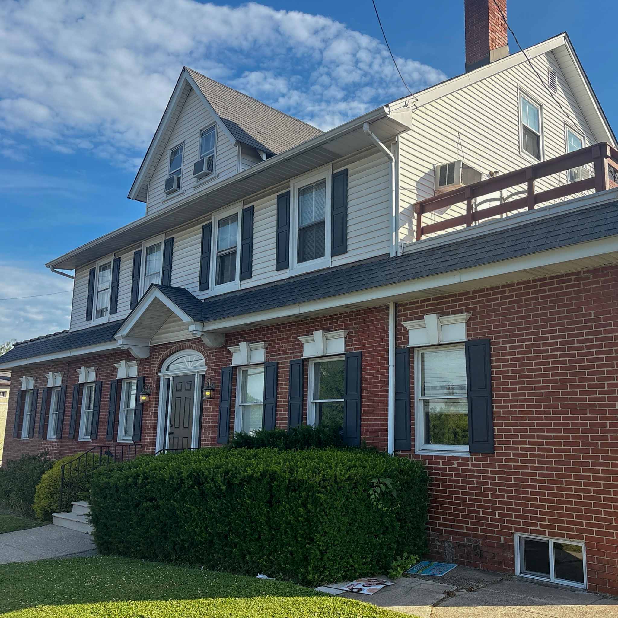 Older brick-and-frame home in Norristown, PA with clapboard upper floors and a gabled dormer, inspected by a ValueGuard home inspector